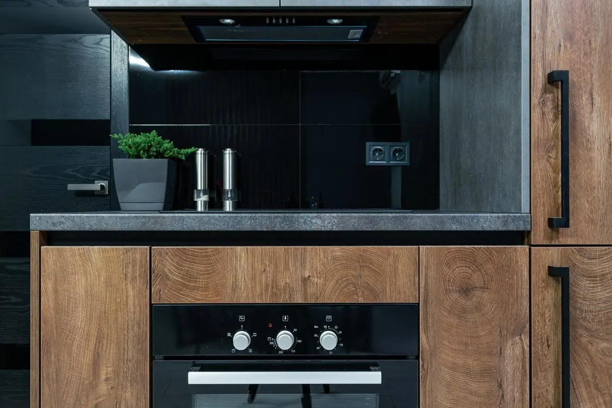 A finished kitchen counter in dark timber and stone