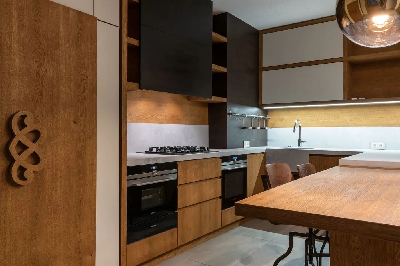 A finished kitchen with timber cabinets and morning light across the counter