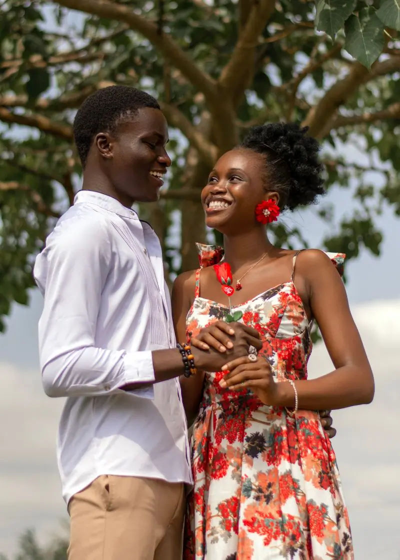 Adjoa and Yaw laughing together outdoors