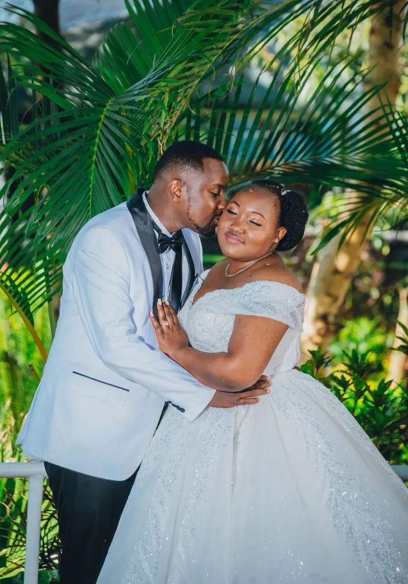 Naa Dedei and Kofi on their wedding day in a garden