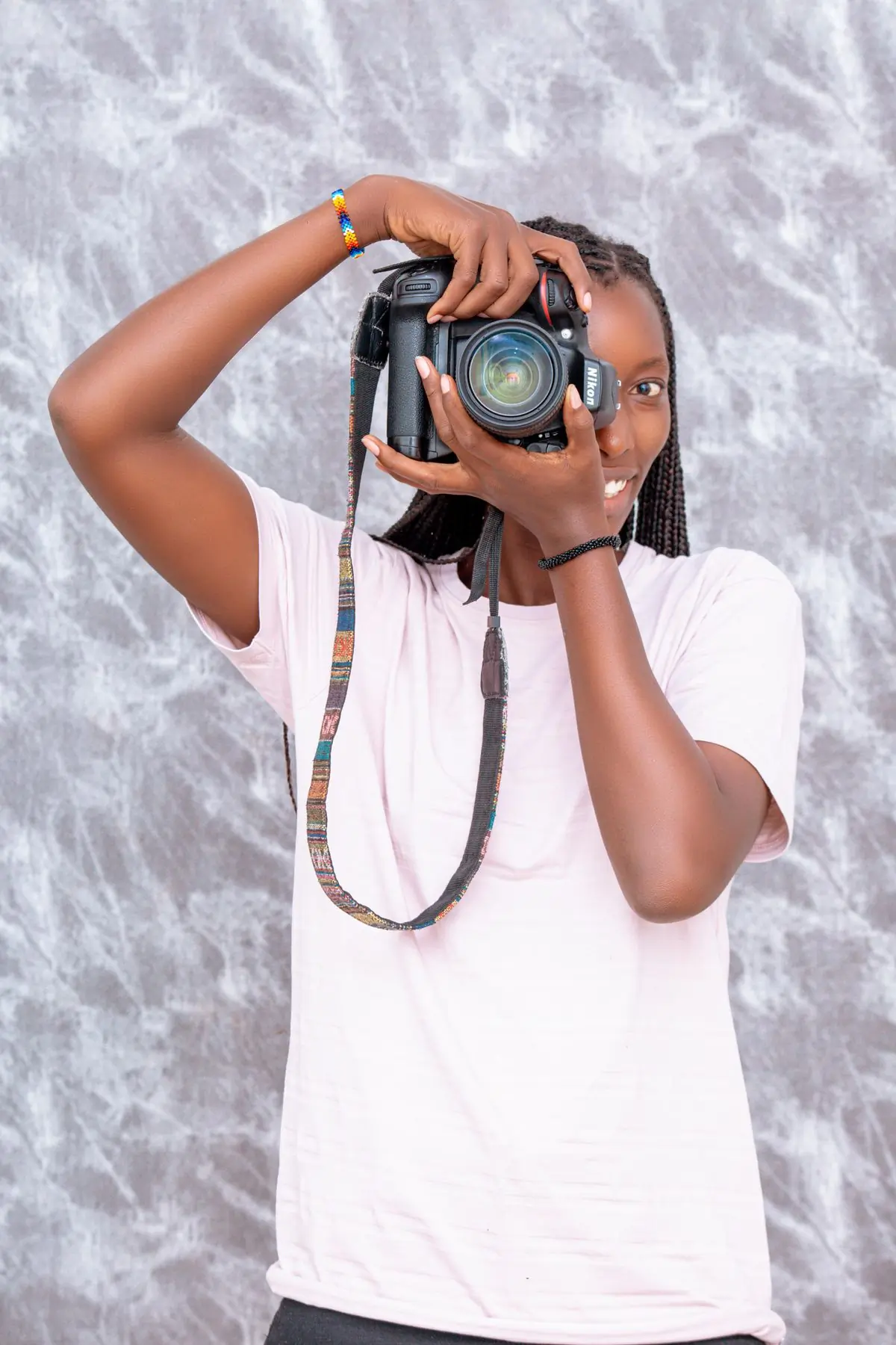 The photographer at work with a camera raised to her eye