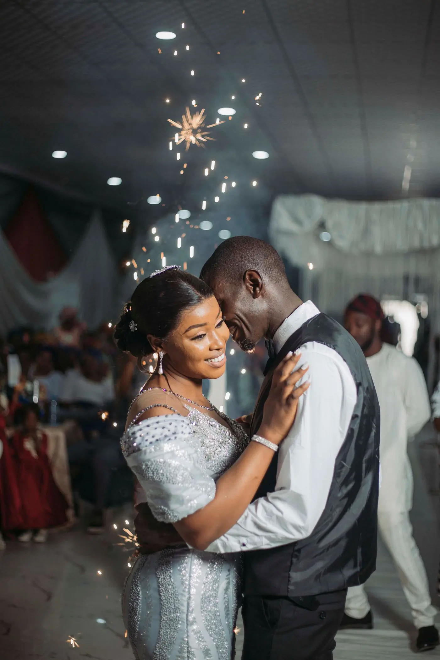 A bride dancing under coloured light at her reception