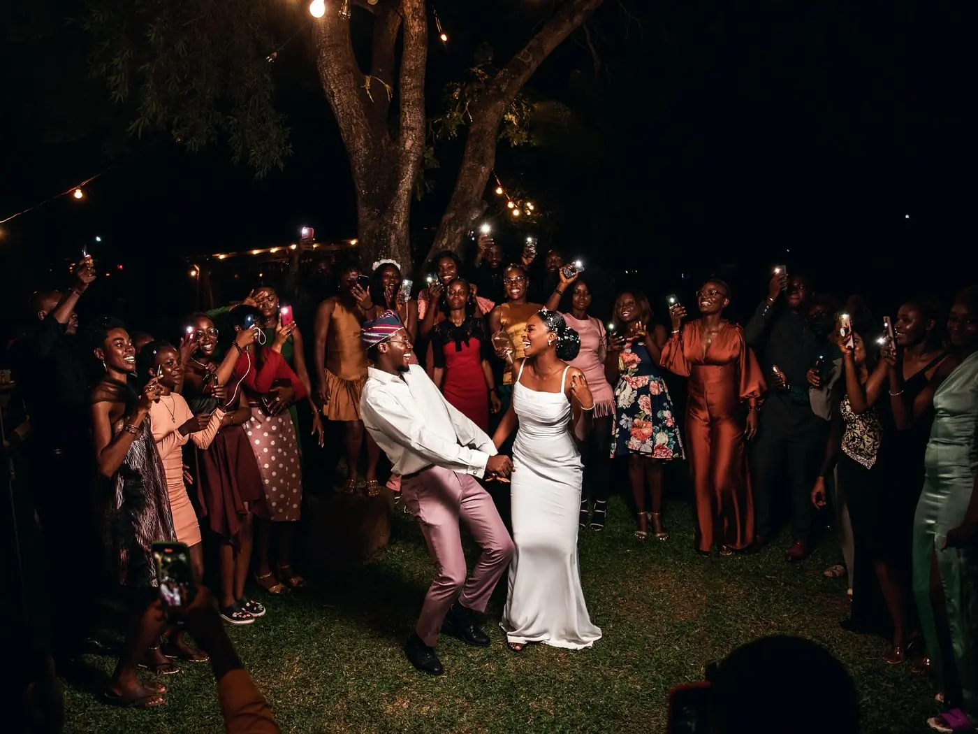 Guests dancing with the couple at a wedding reception