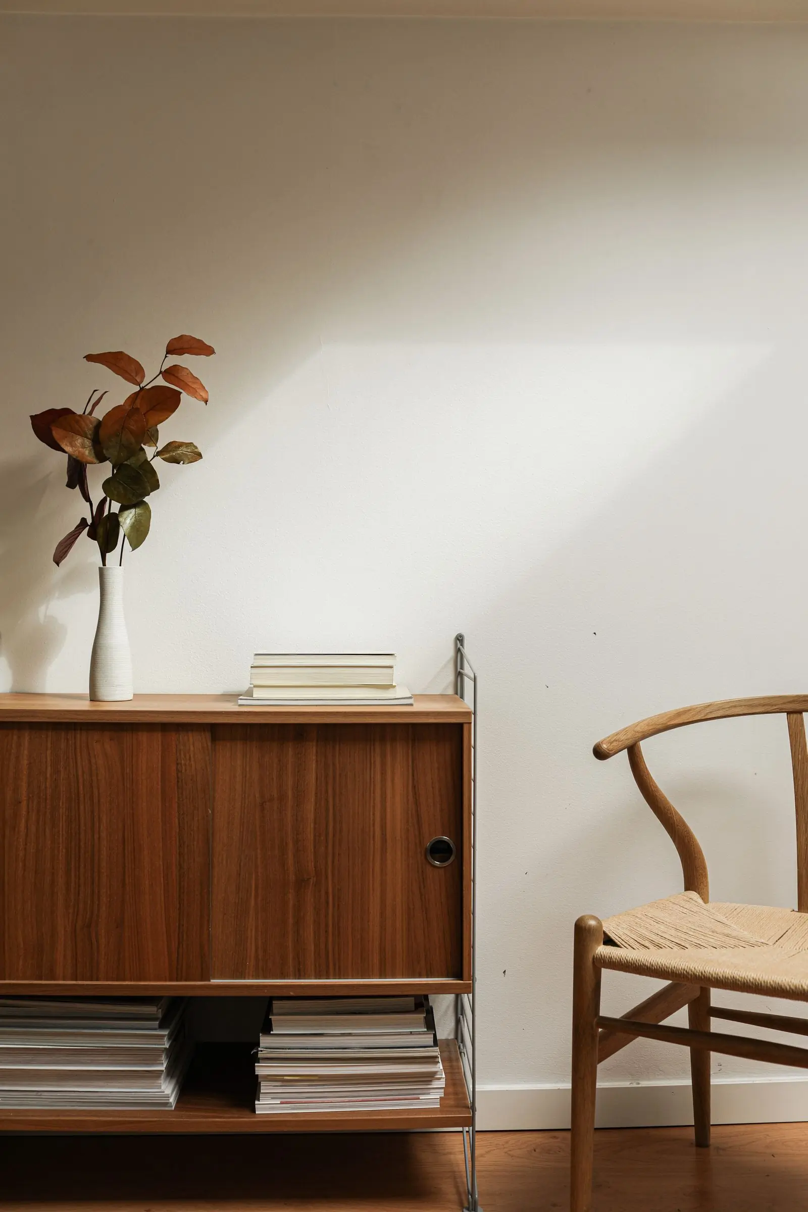 A styled corner with an armchair and a floor lamp