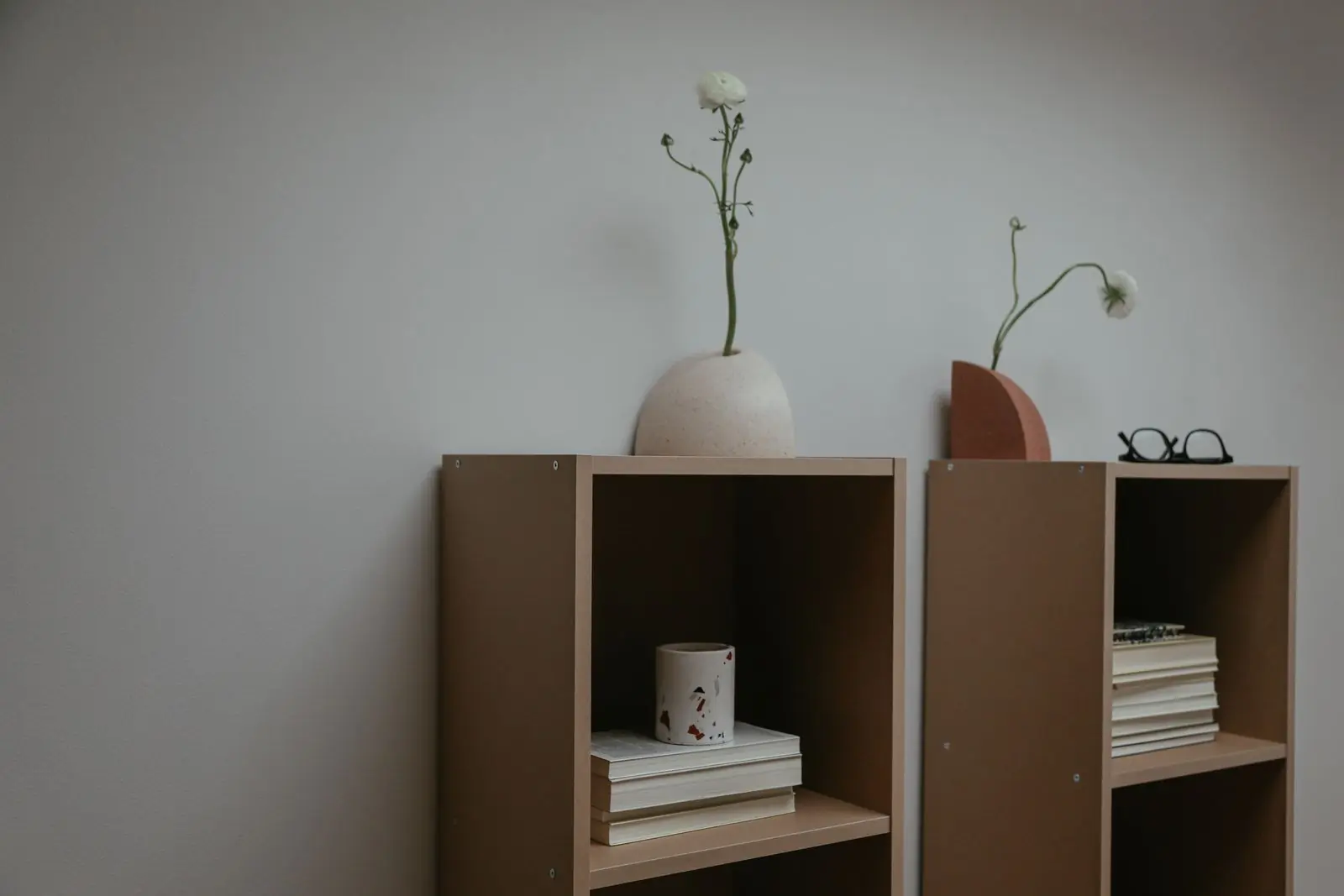 A tall bookshelf filled with books and ceramics