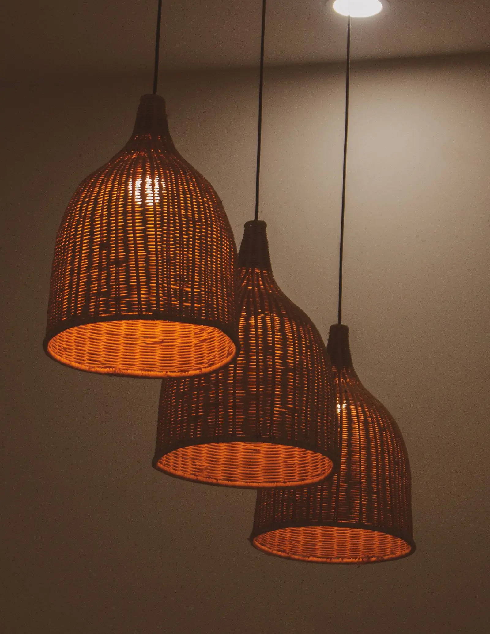 A sculptural pendant lamp hanging over a table