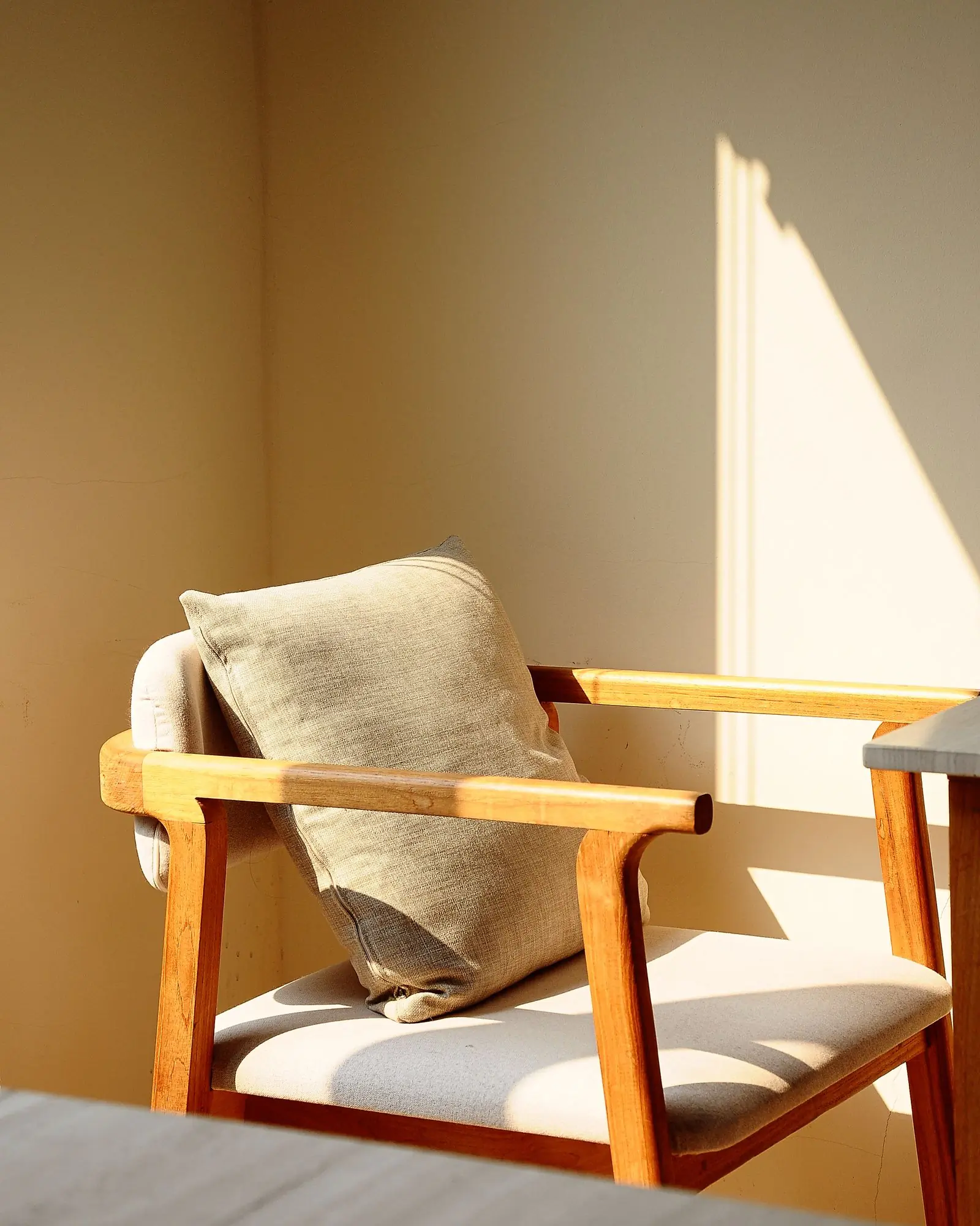 A wooden rocking chair on a woven rug