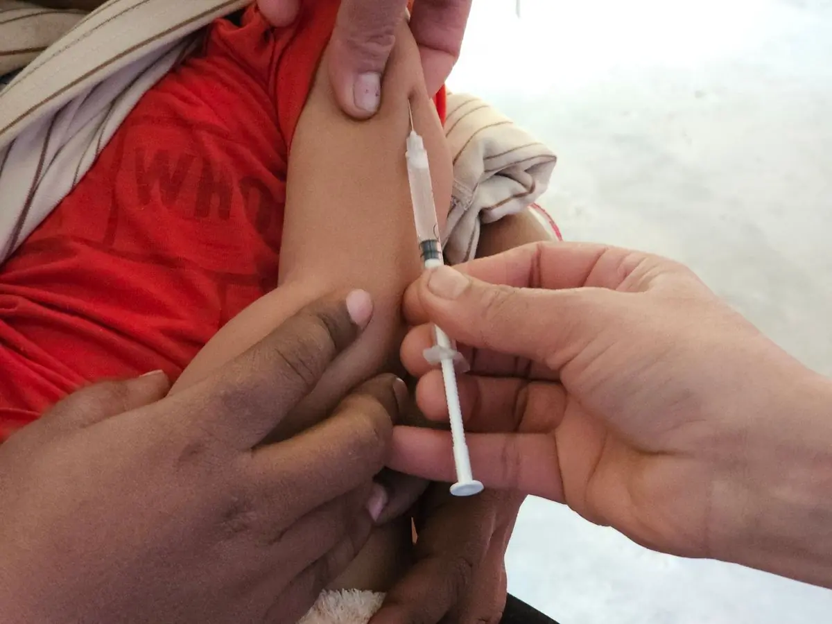 A child receiving a routine immunisation