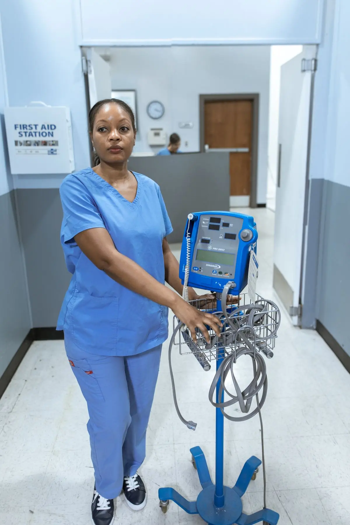 A nurse moving equipment through the emergency department