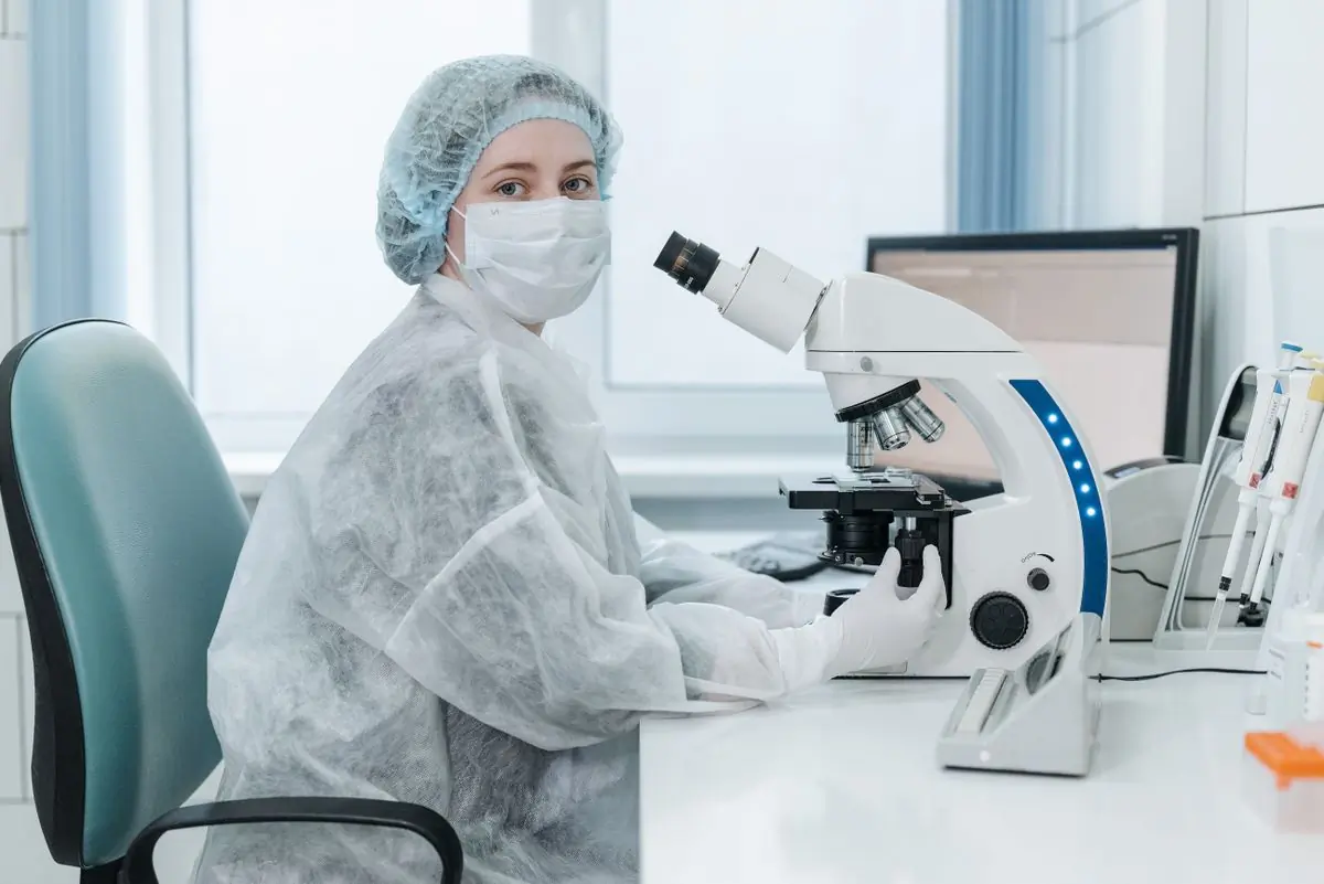 A laboratory scientist at the microscope in the hospital's own lab