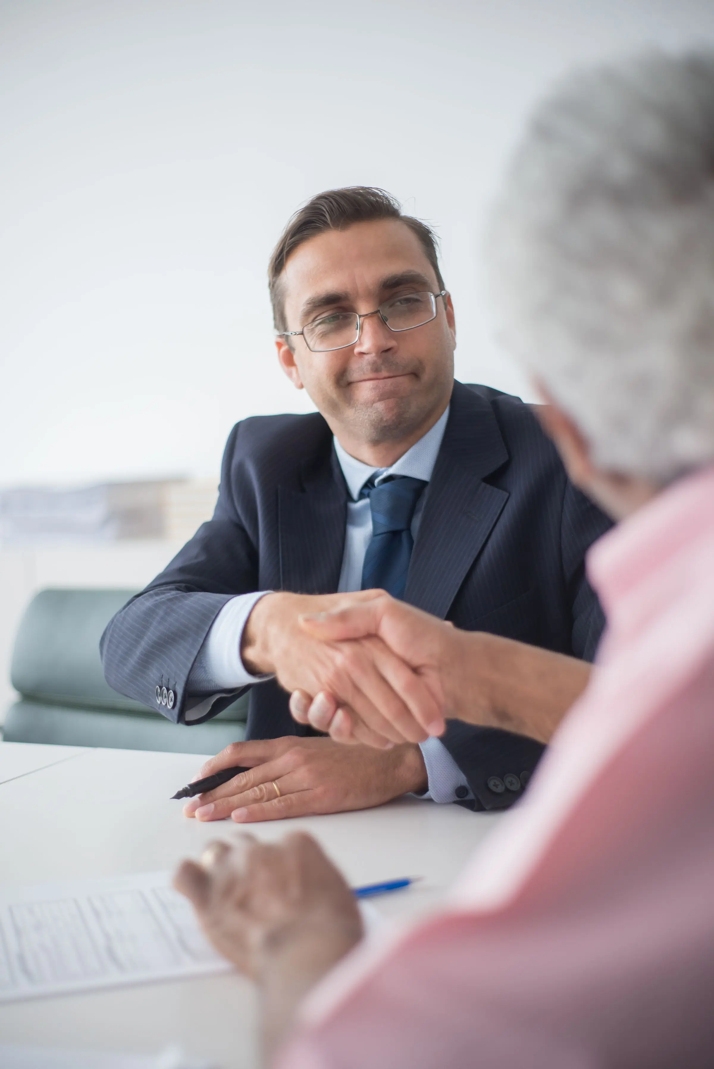 A partner meeting a client across the table