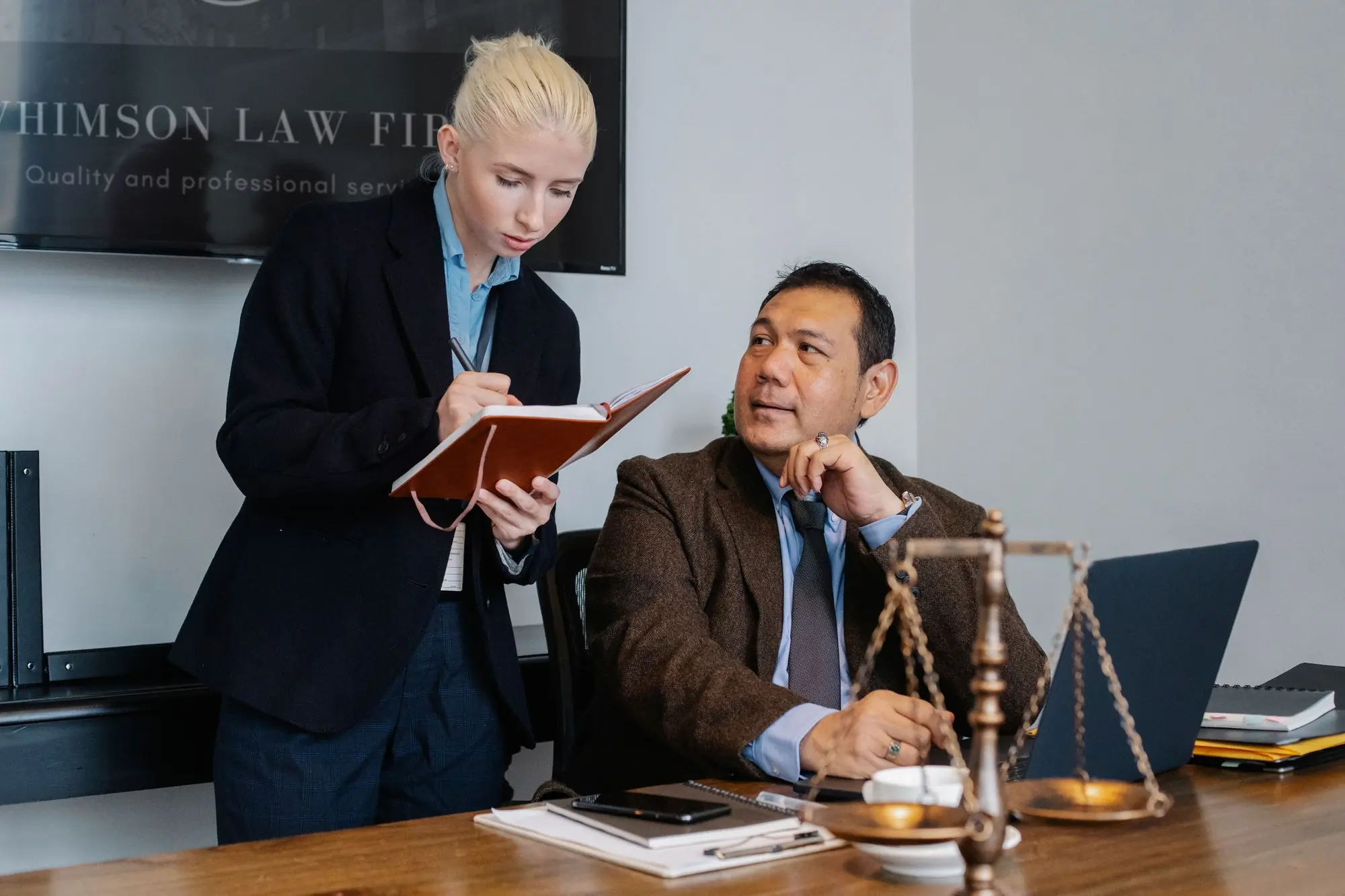 Two colleagues reviewing an employment file together