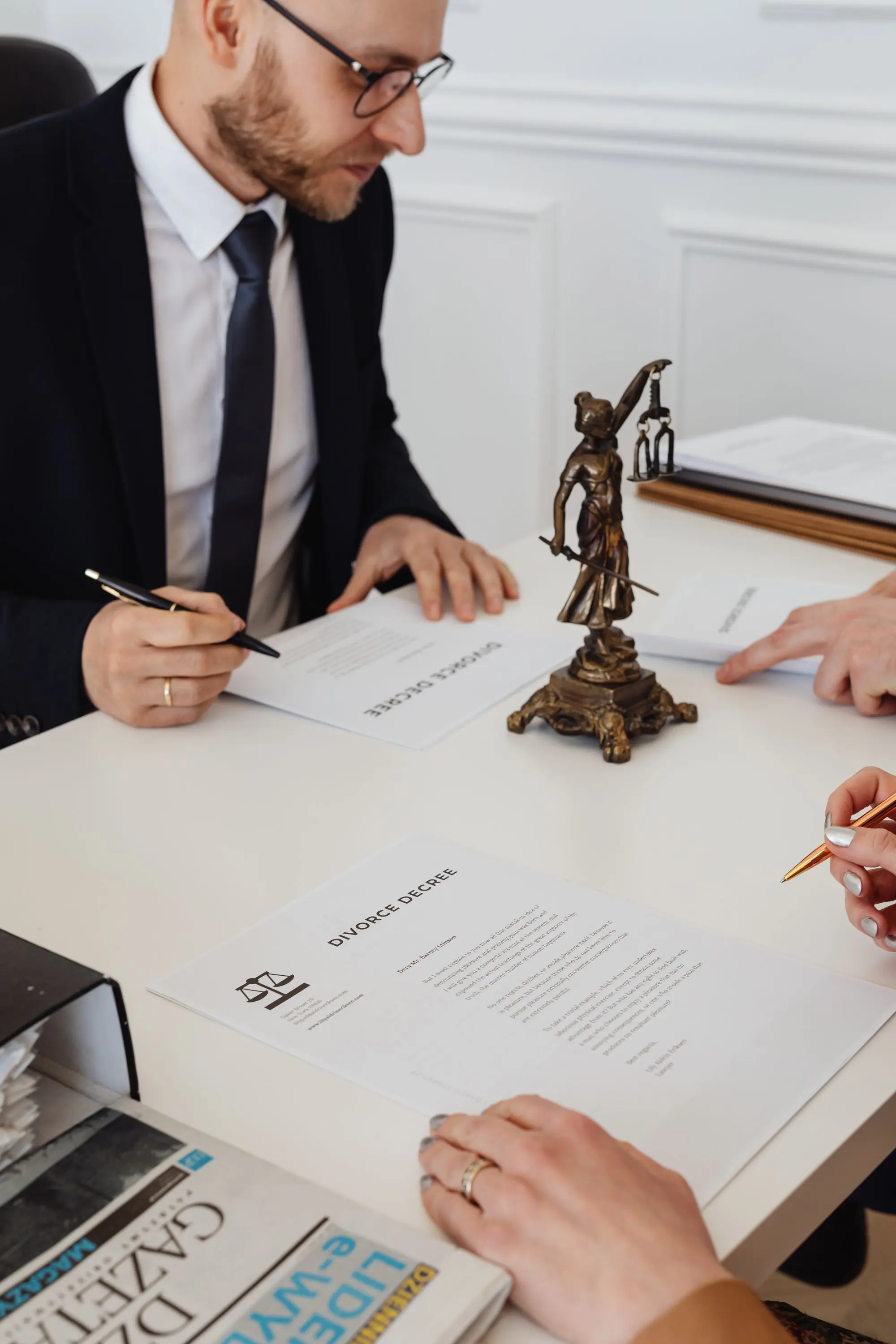 A client signing estate documents with counsel present