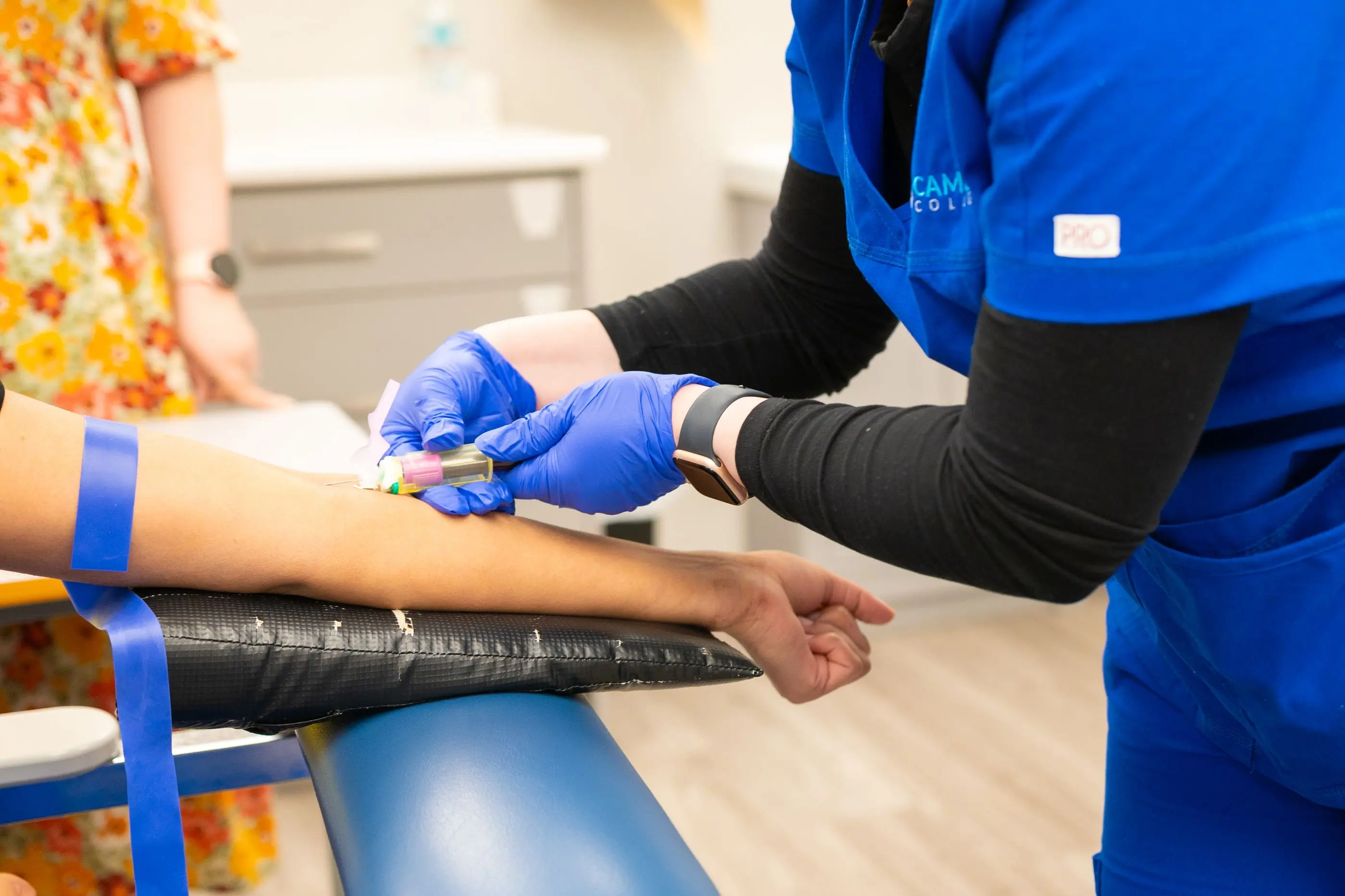 A phlebotomist drawing a blood sample at a collection point