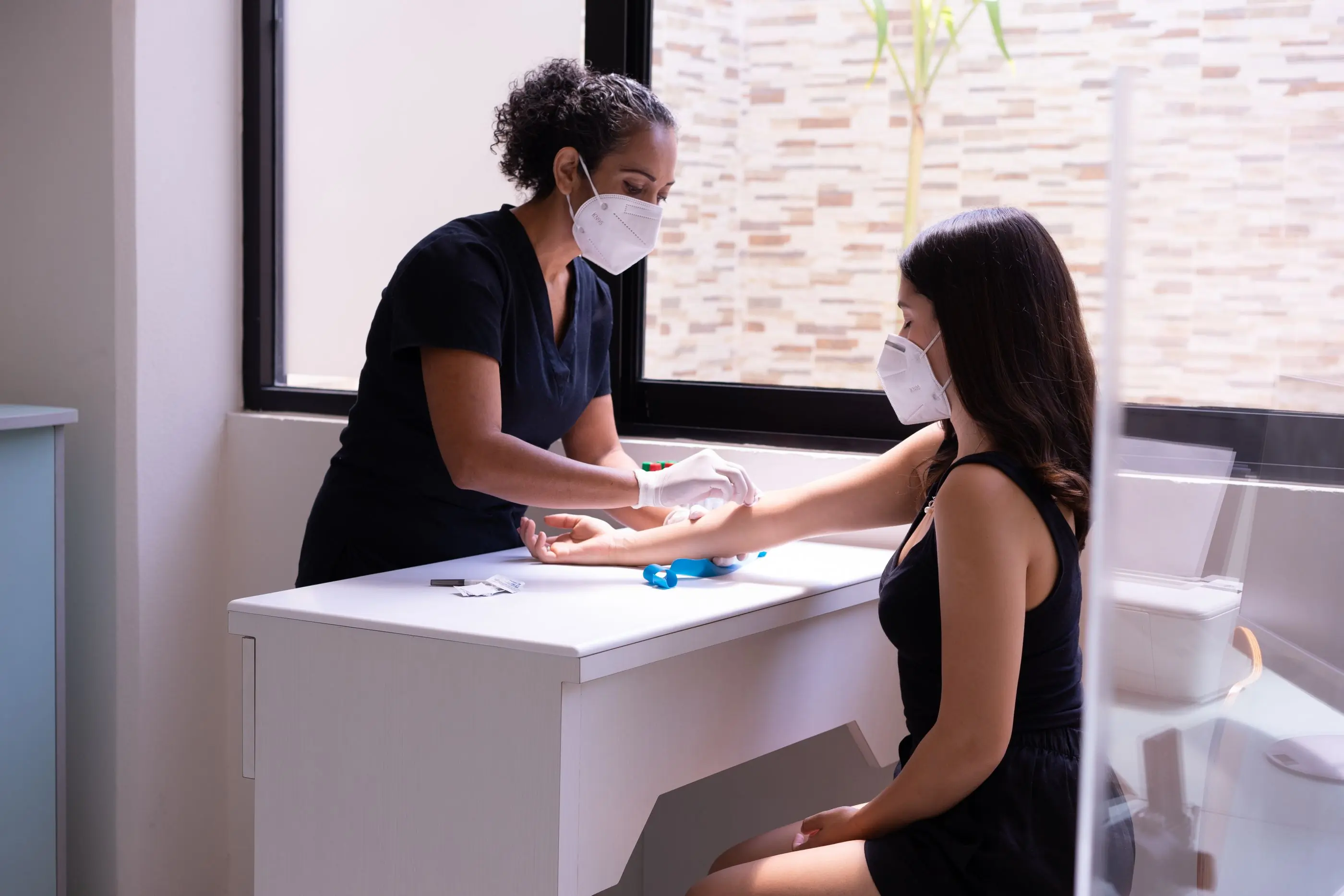 A phlebotomist preparing a patient's arm for a sample