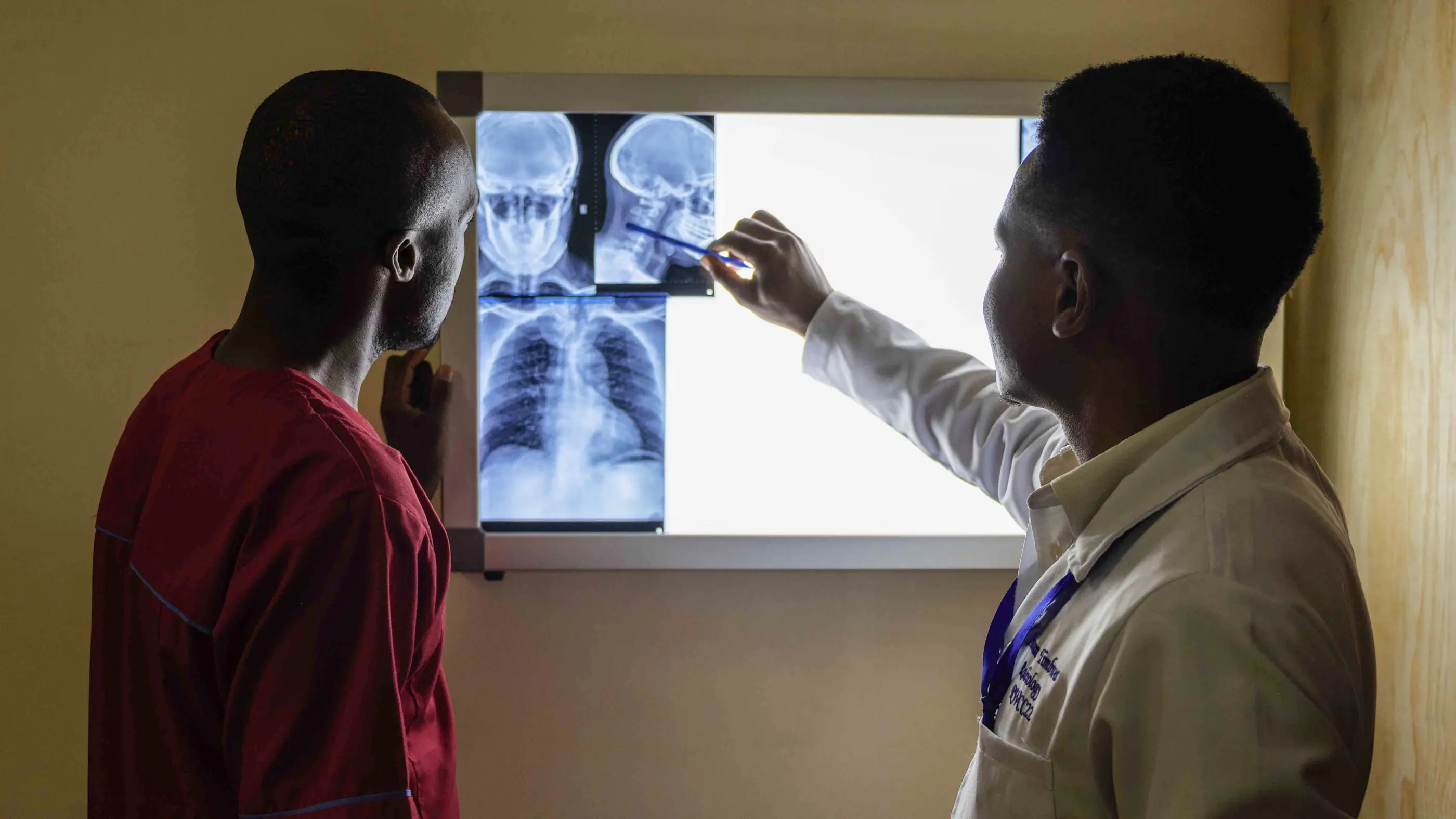 A clinician talking a patient through their results on screen