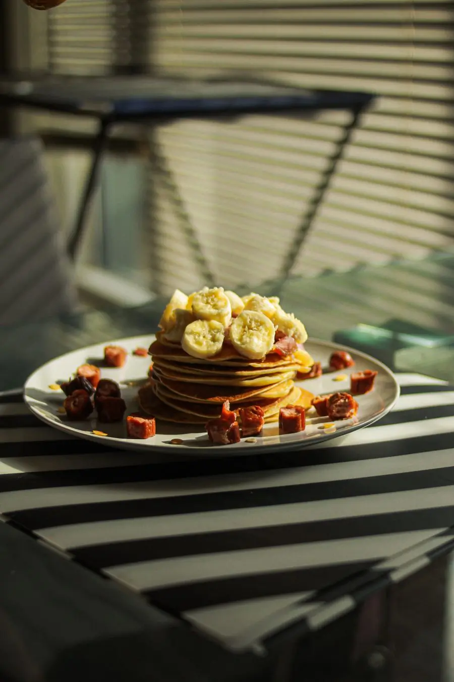 A stack of pancakes topped with banana