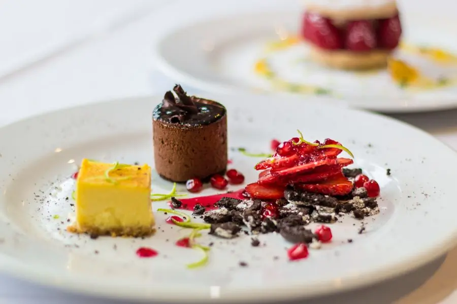 A chocolate dessert plated with berries