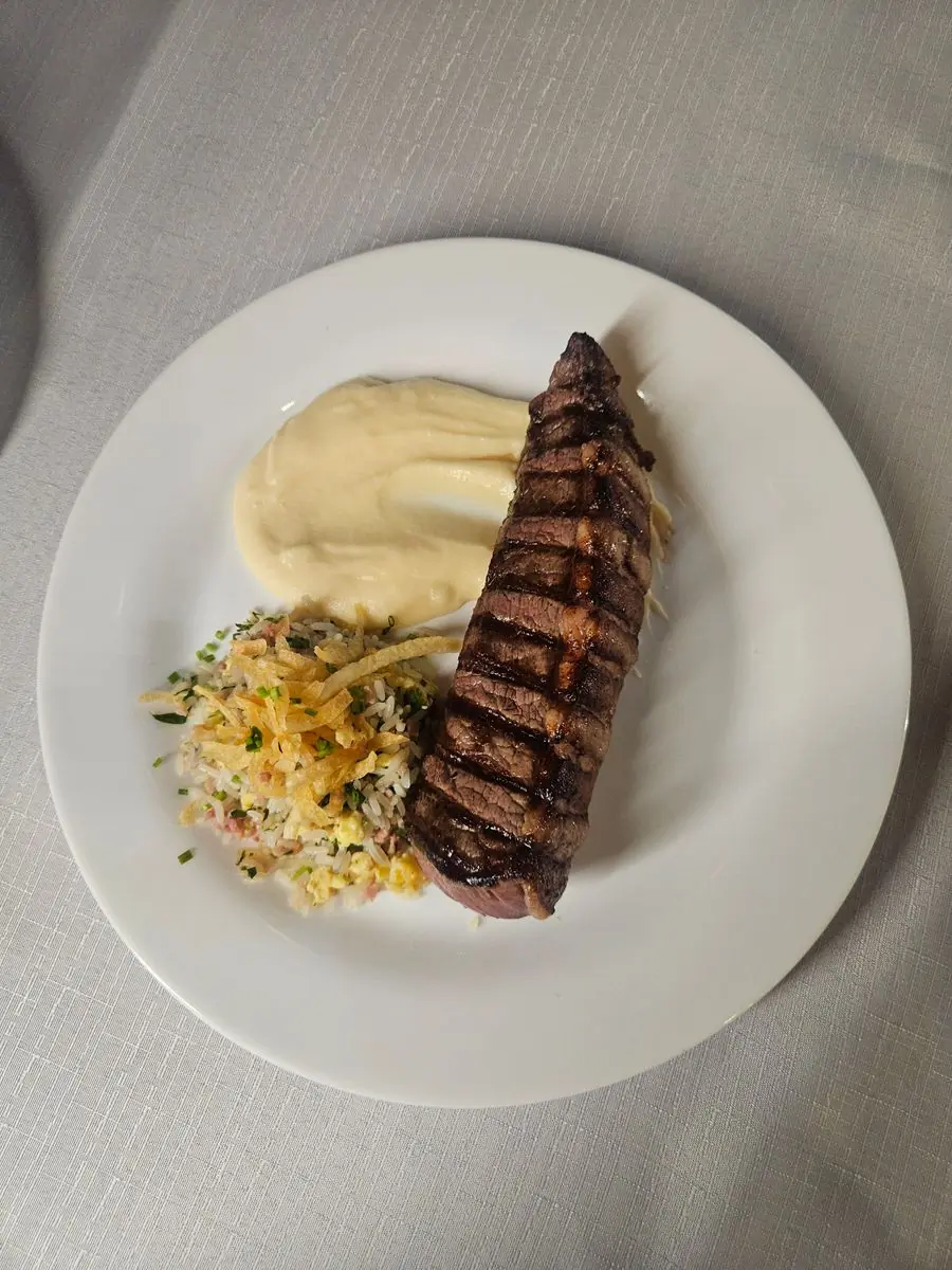 Grilled steak with mashed potato and rice