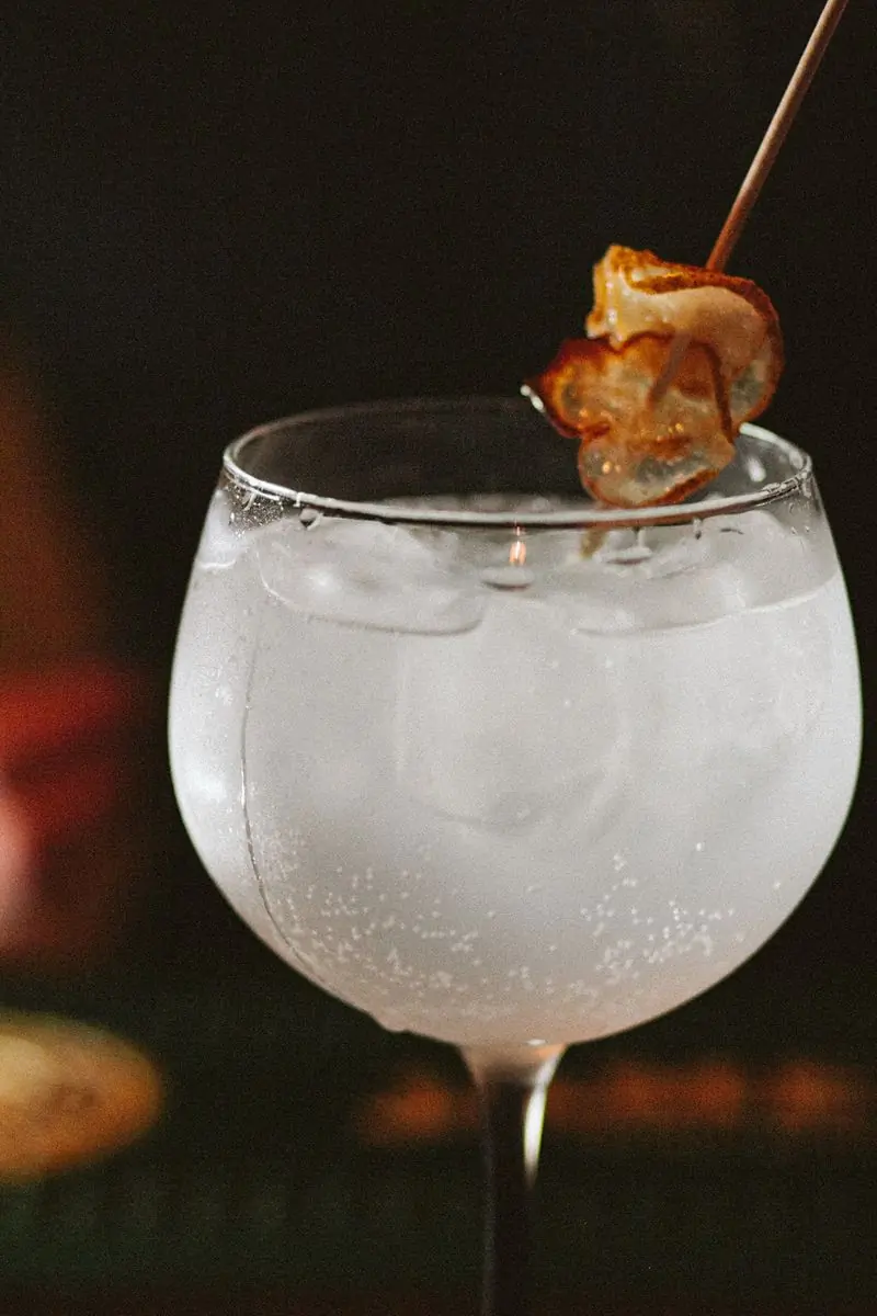 A frothy sour in a bowl glass