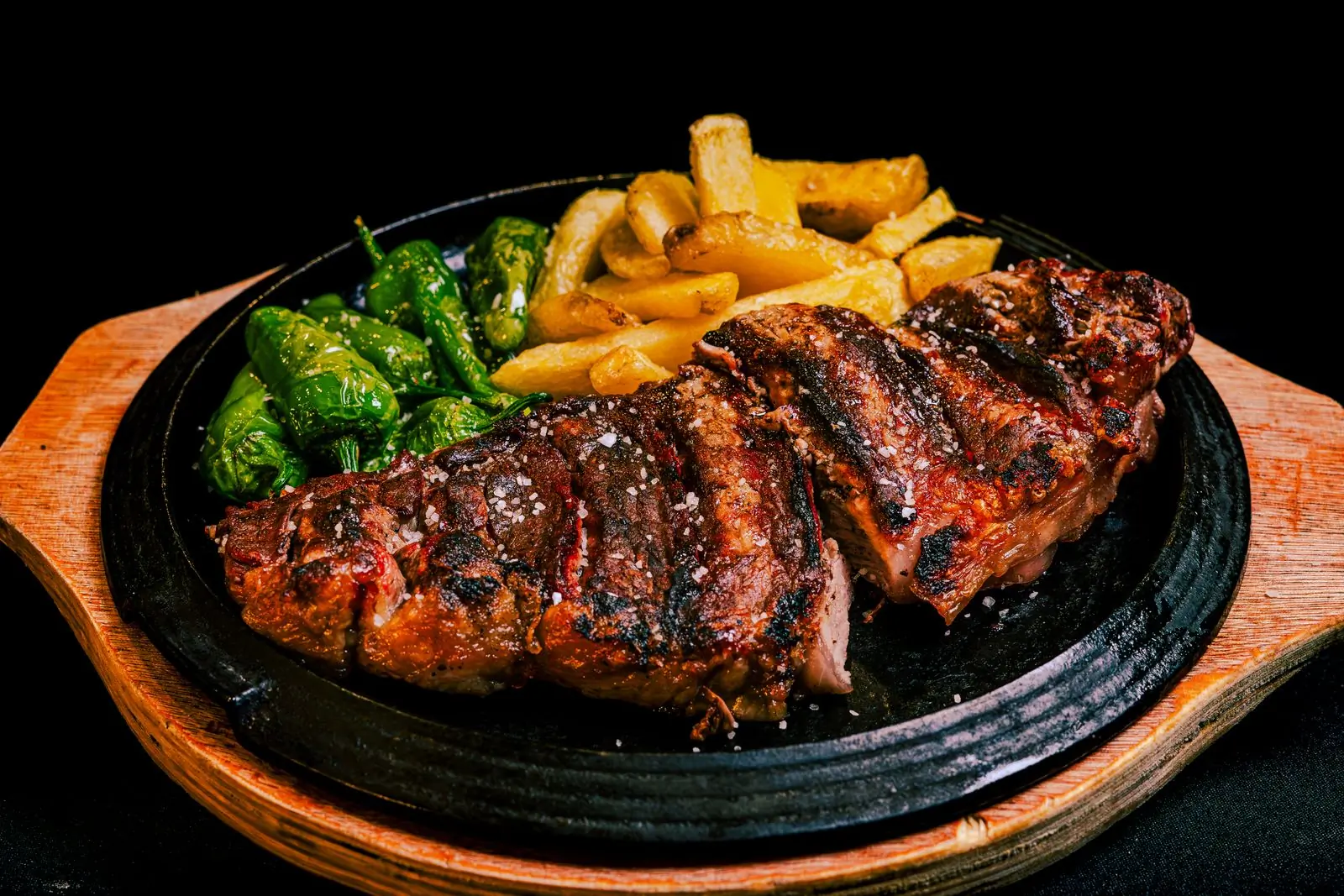 Sirloin and hand-cut chips on a dark plate