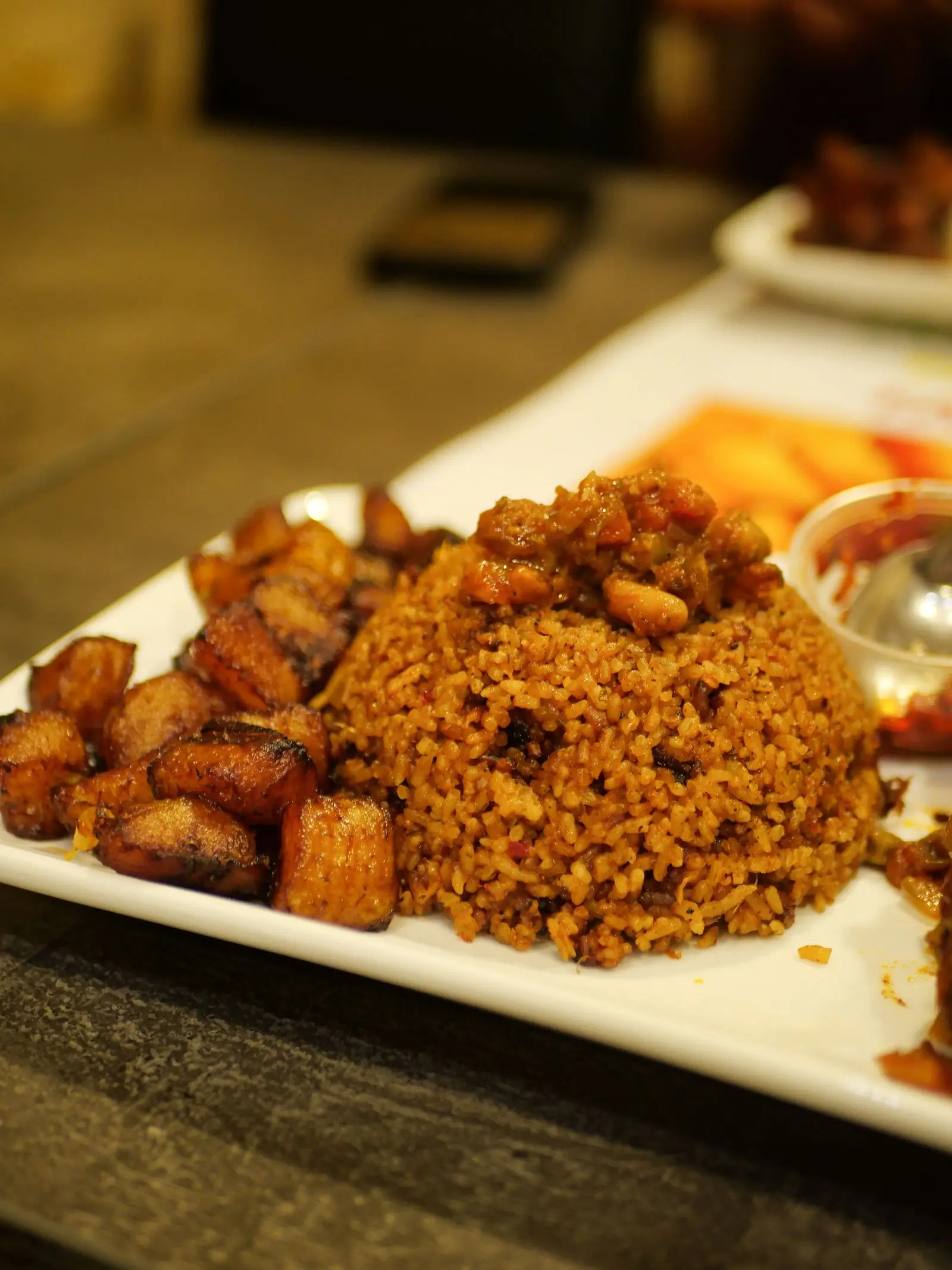 Jollof rice with fried plantain and grilled chicken