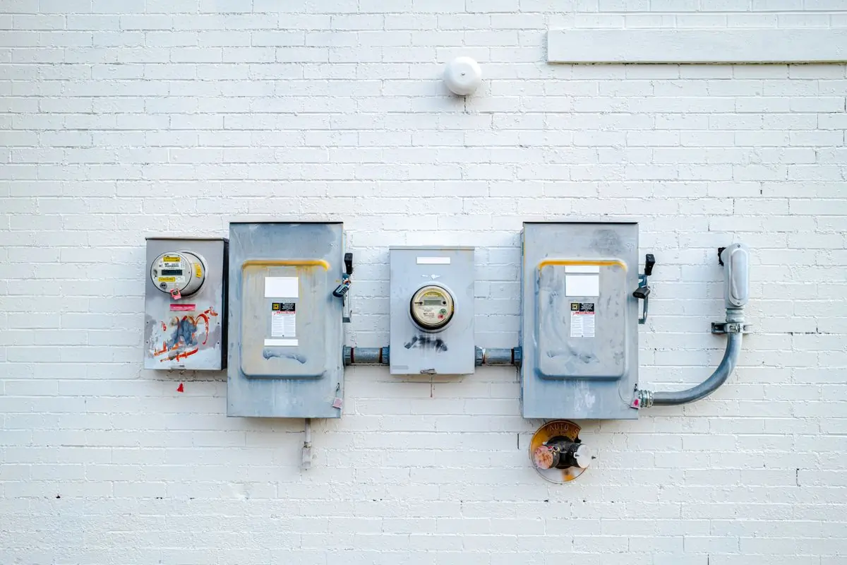A run of tenant meters and isolators mounted on a white wall