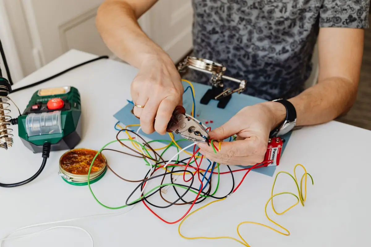 An electrician making off a bank of control wiring