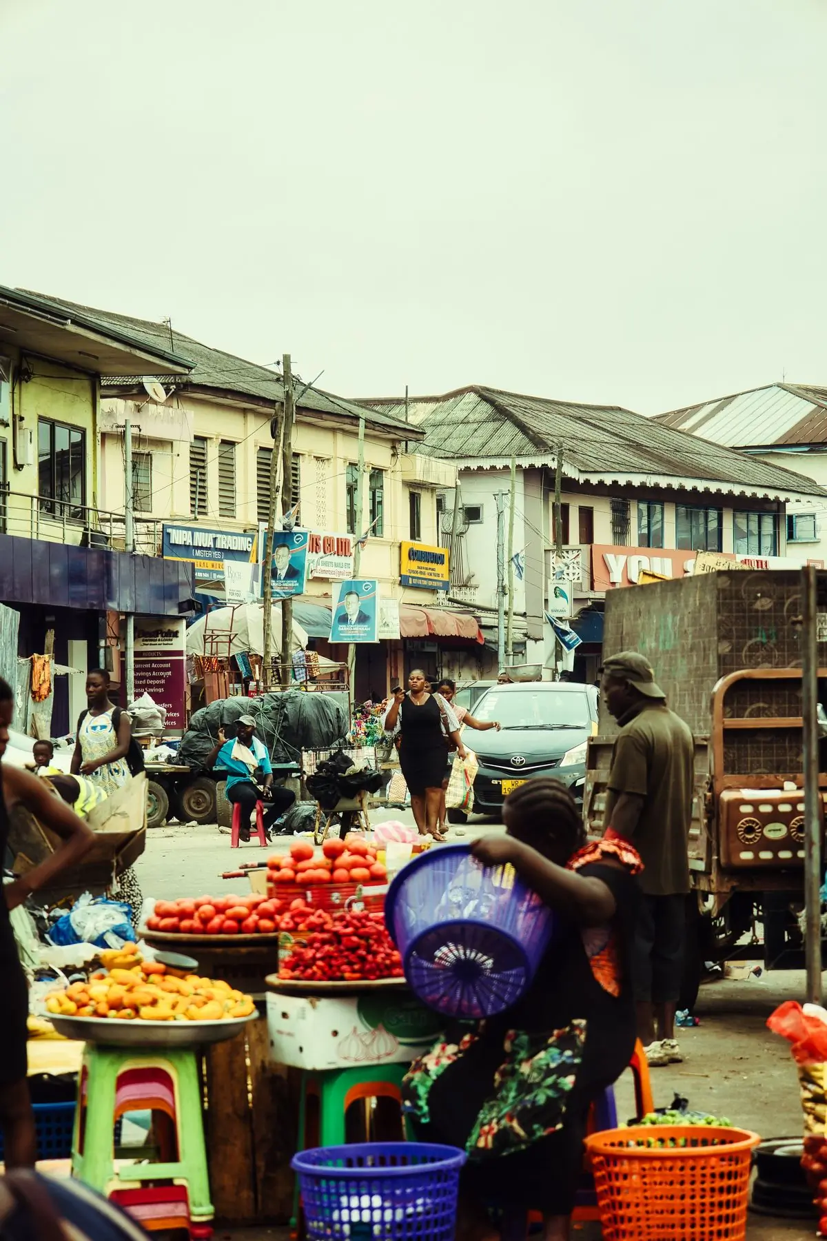 A busy Accra street of traders and traffic in the afternoon
