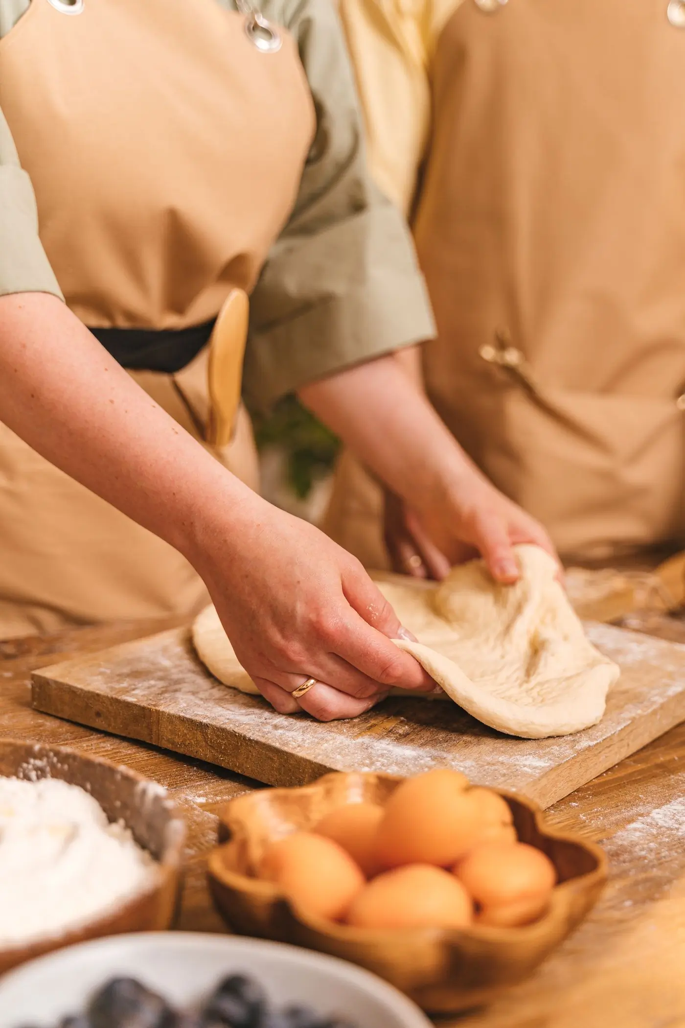 Hands working dough at the counter during a Saturday class