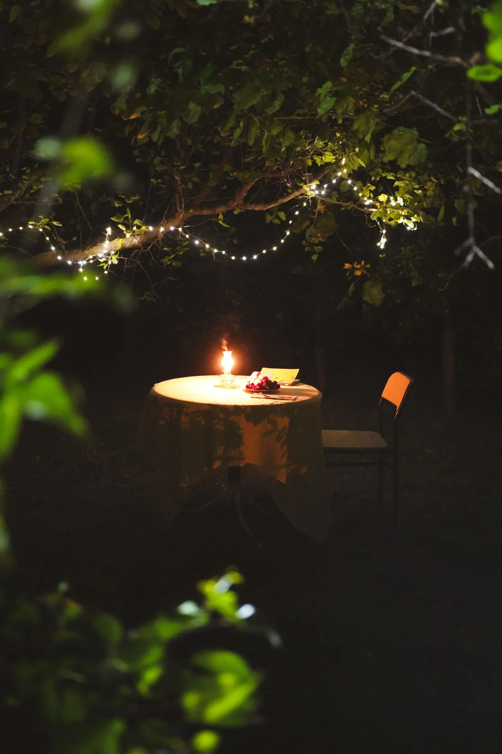 A candlelit table laid for the evening service