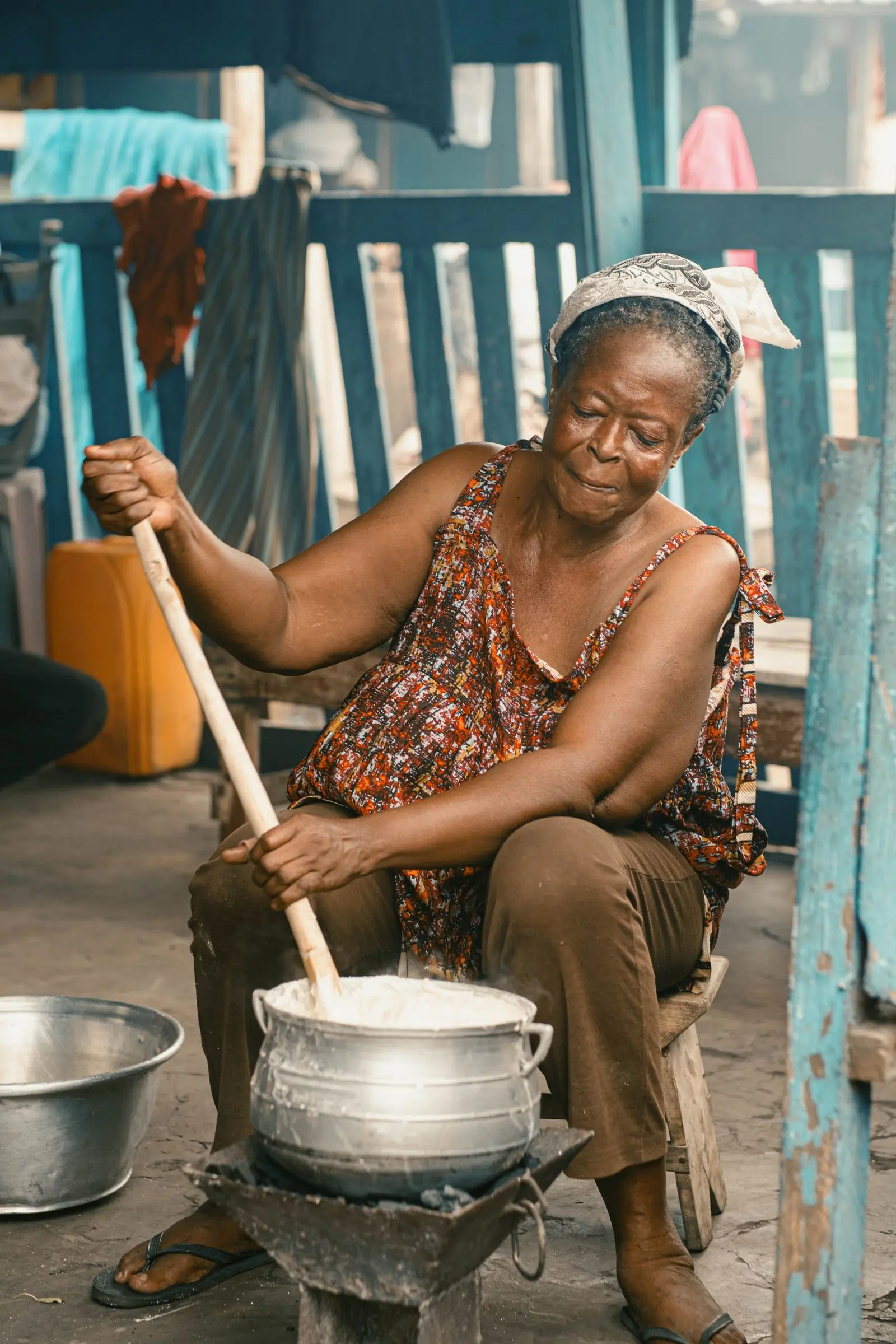 Auntie Mansa at the coalpot, cooking the way the kitchen still cooks