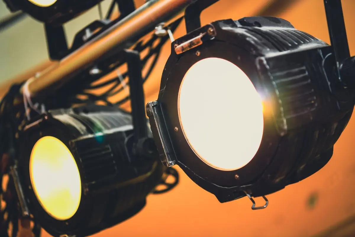 Two fresnel lamps in close-up against a warm background