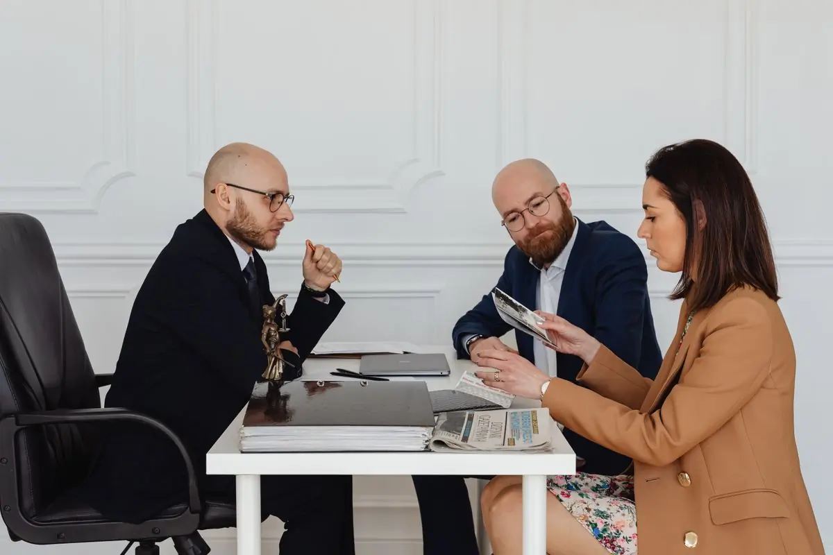 A property adviser holding land documents at a meeting