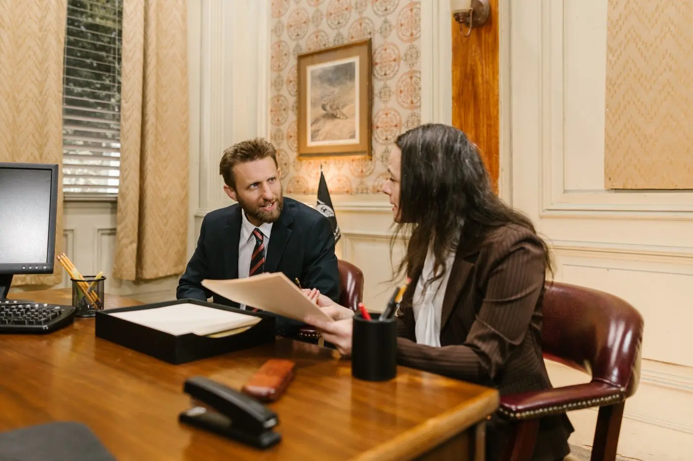 Two advocates reviewing a matter in the firm's meeting room