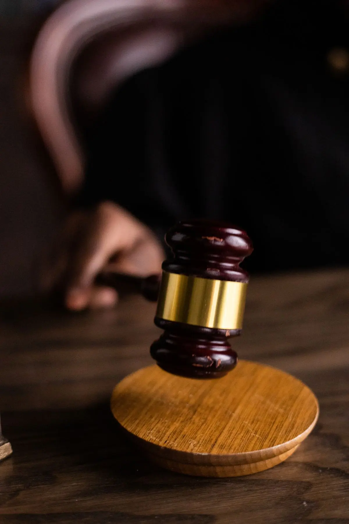 A gavel resting on a wooden desk