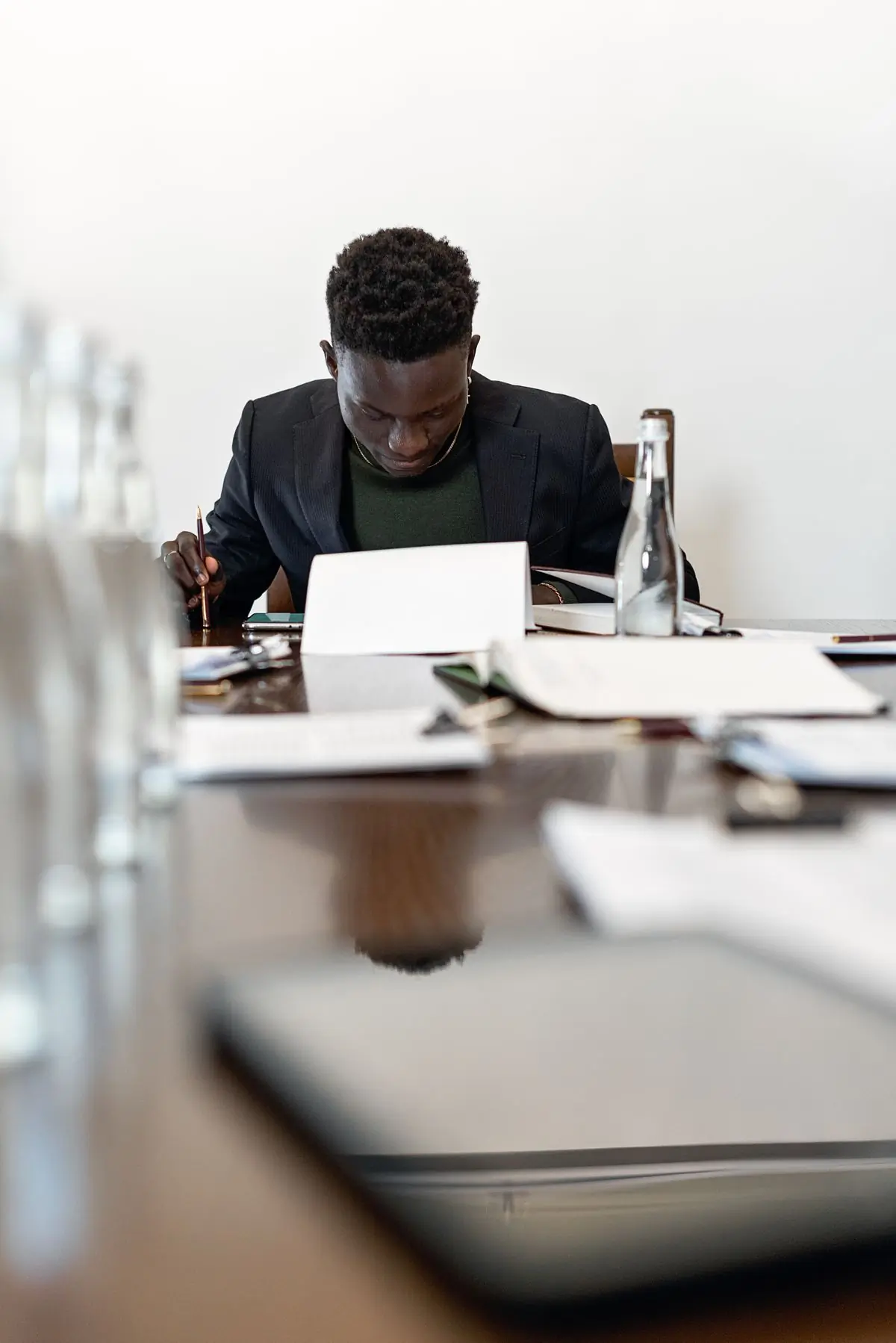 An employer signing documents at an office desk
