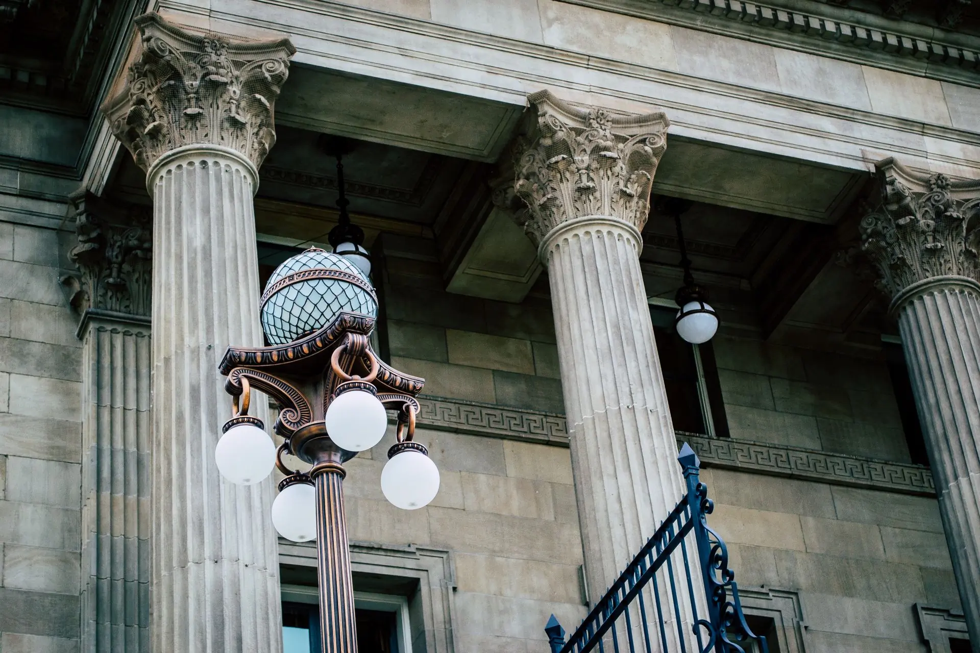 The colonnade of a courthouse seen from below