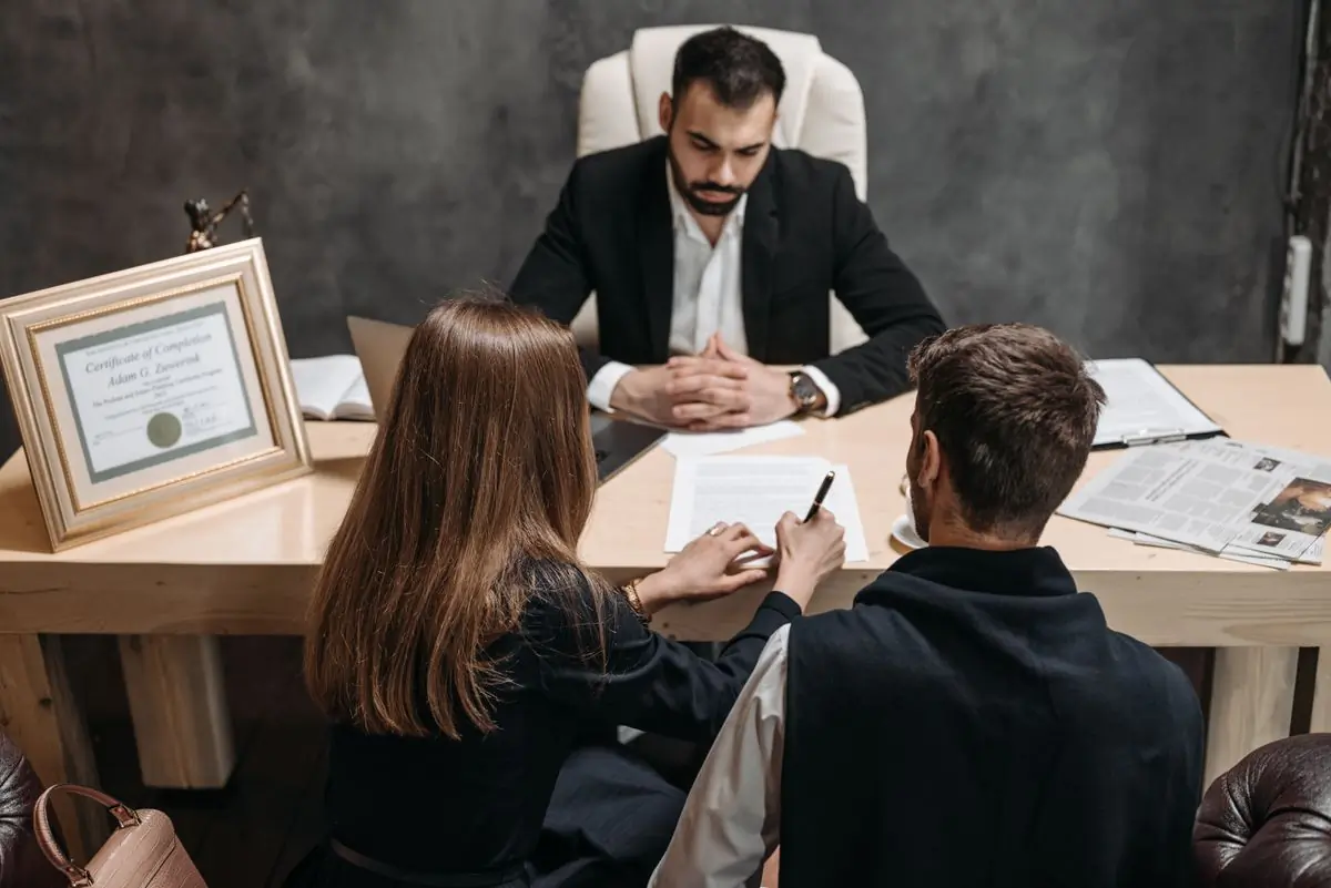 An advocate talking a couple through documents at her office