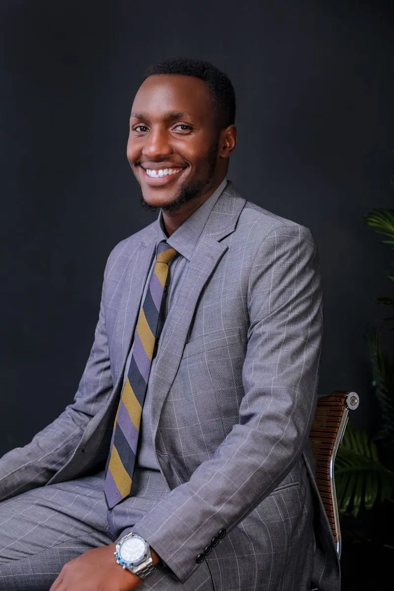 Kofi Adjei-Mensah in a grey suit