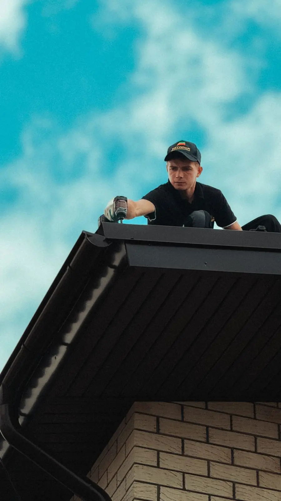A roofer refixing sheets on a house roof