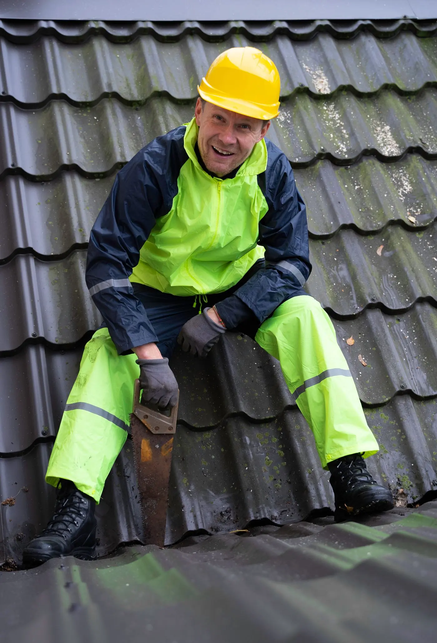 A roofer refixing sheets on a house roof