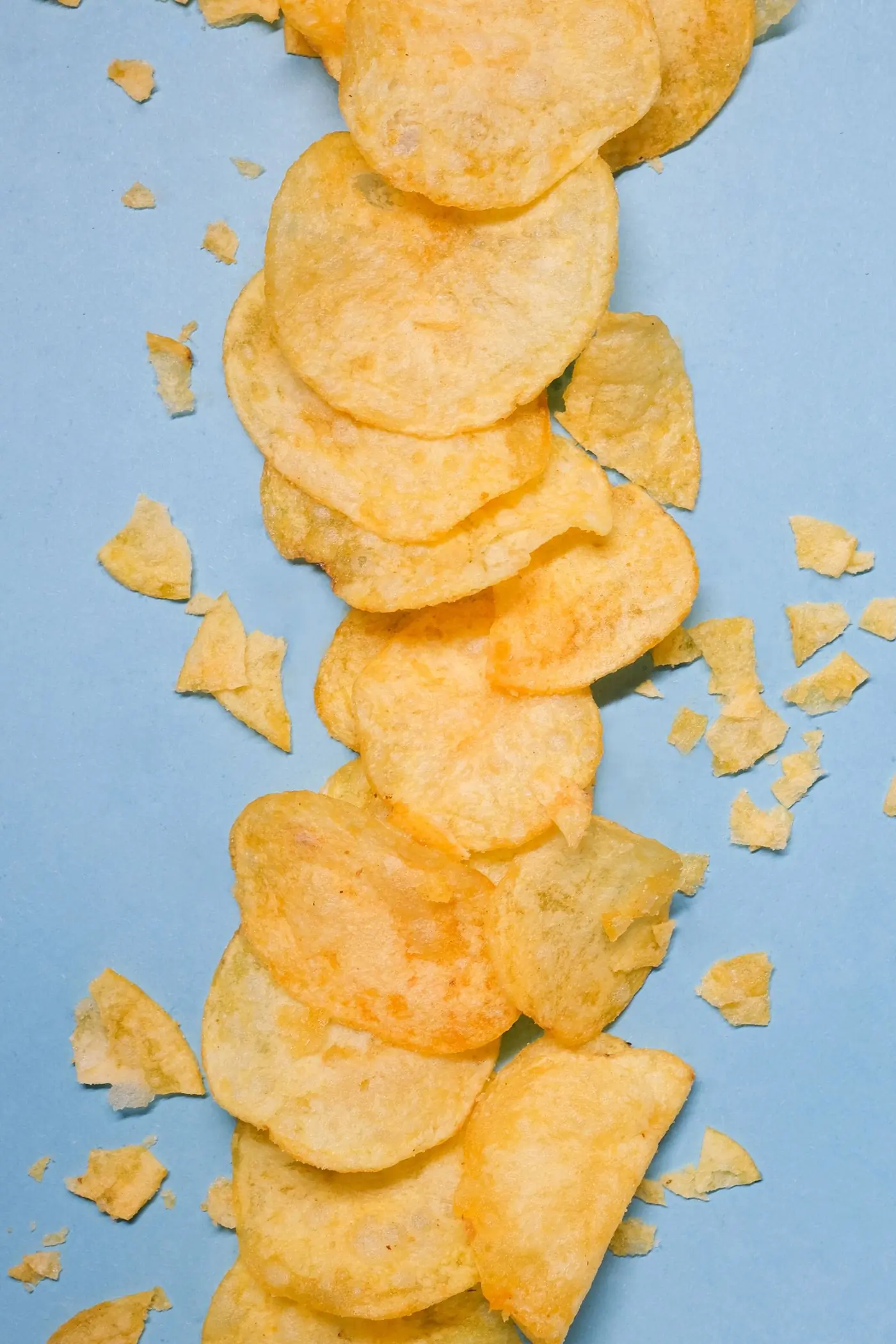 Golden chips laid in a column on powder blue