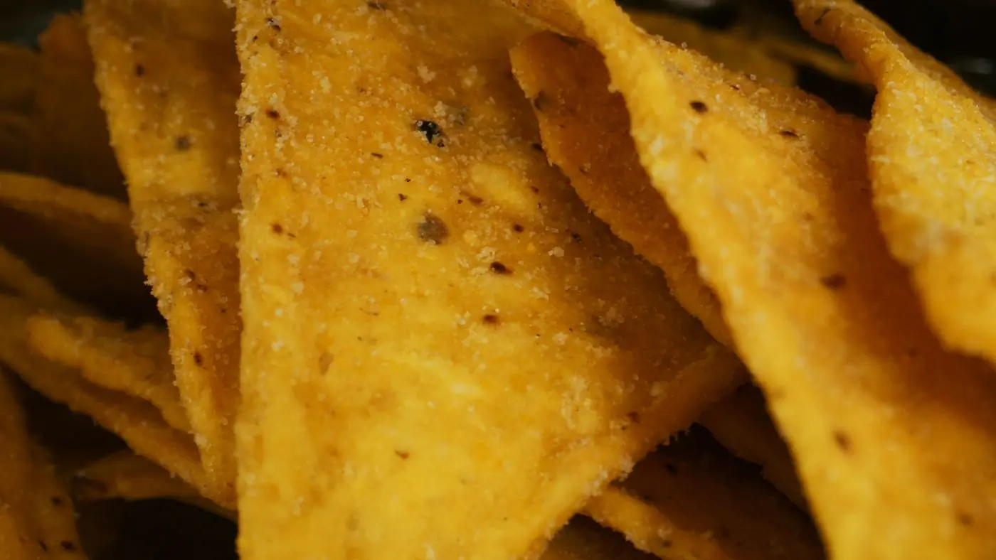 Seasoned nachos glowing against black