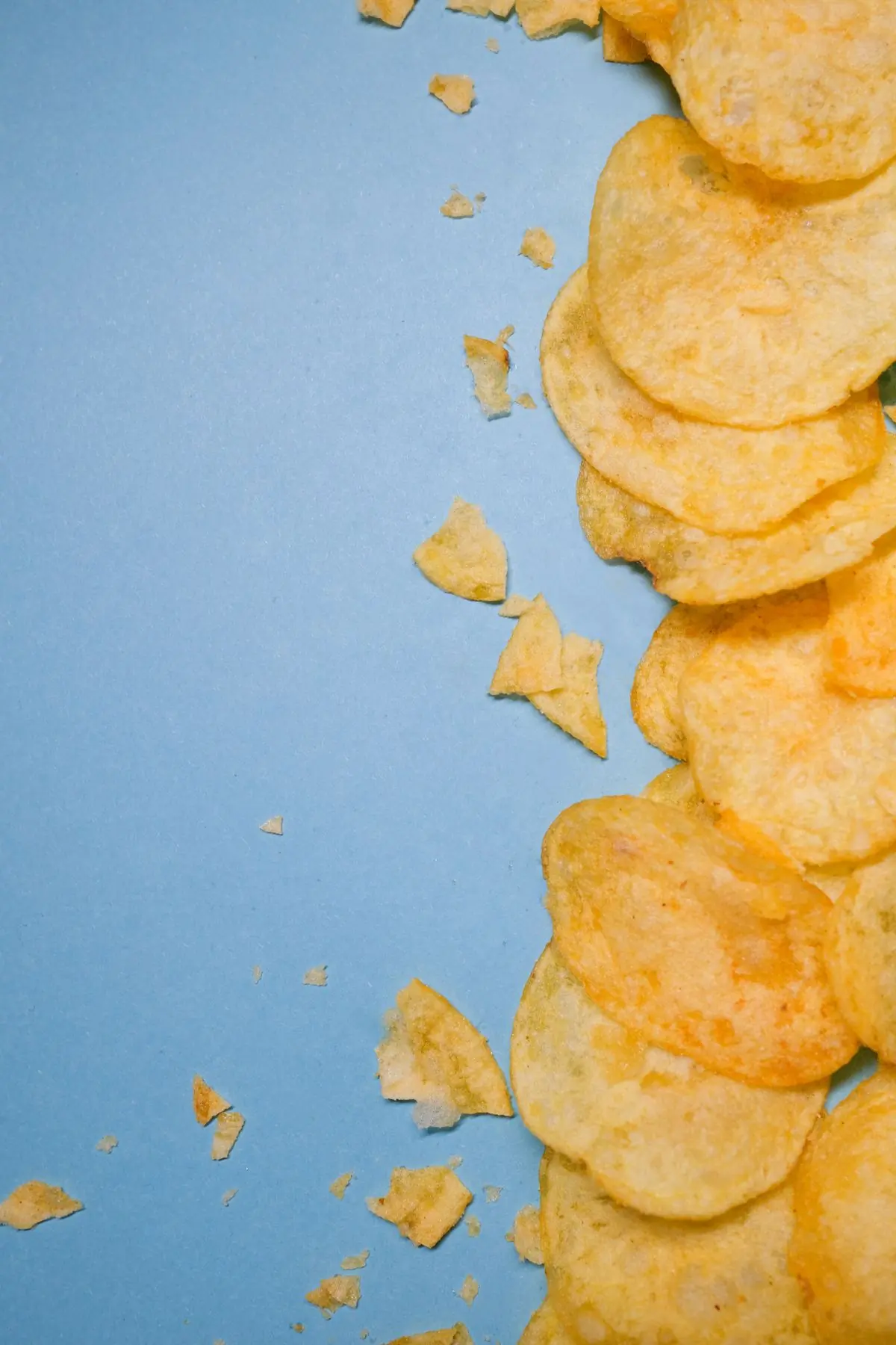 Golden chips along the edge of a powder blue ground with open space beside them