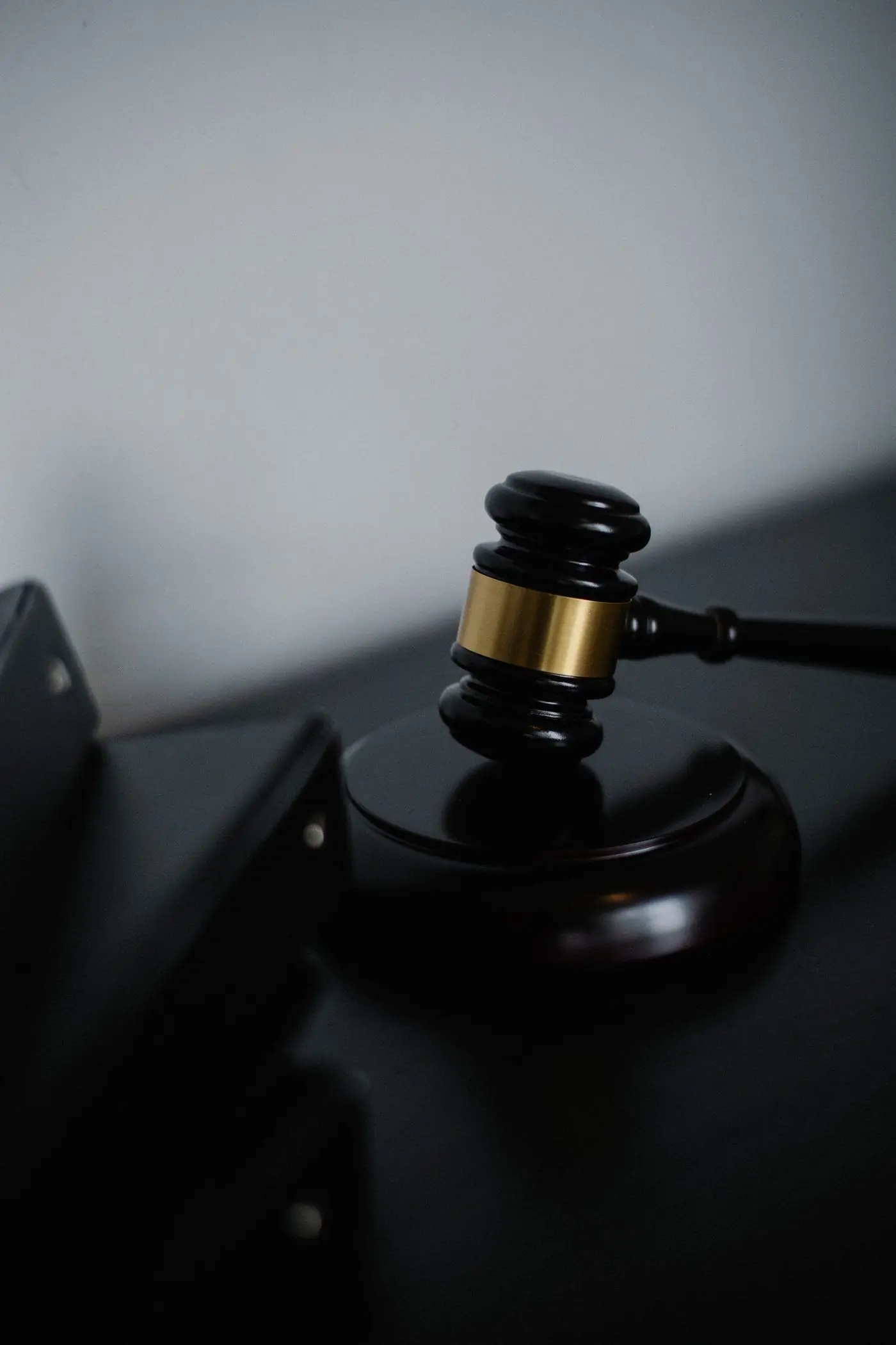 A judge's gavel resting on a courtroom desk