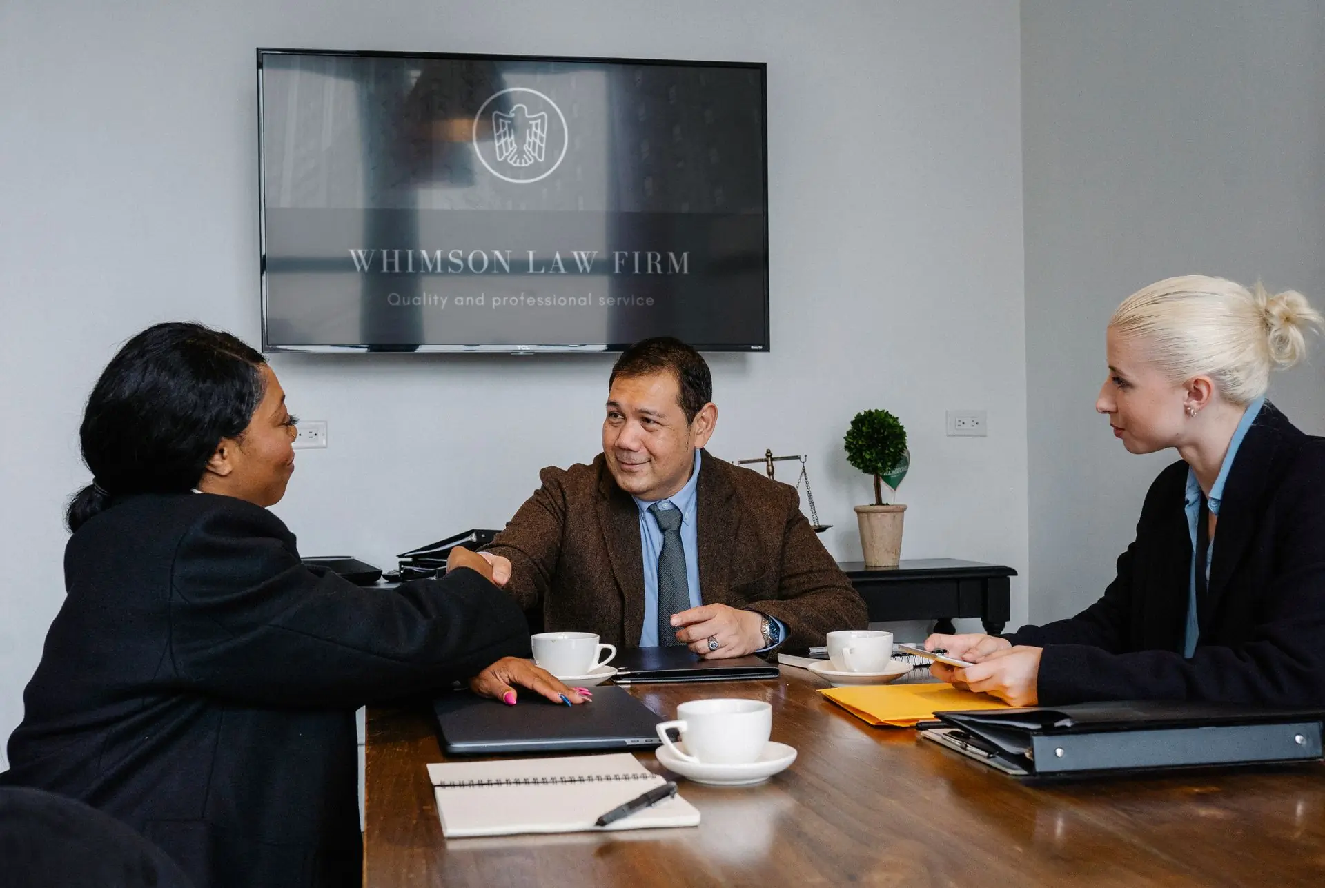 The firm's attorneys meeting a client around a conference table