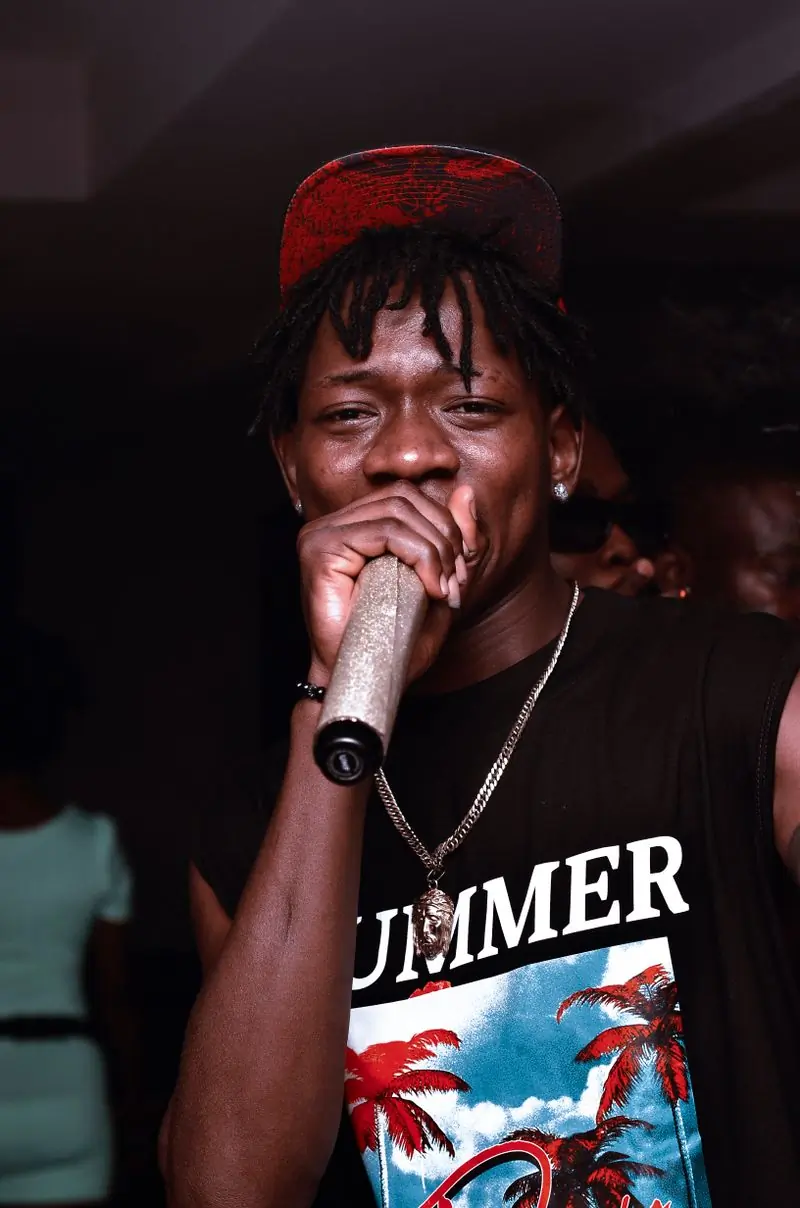 A rapper performing into a hand-held microphone