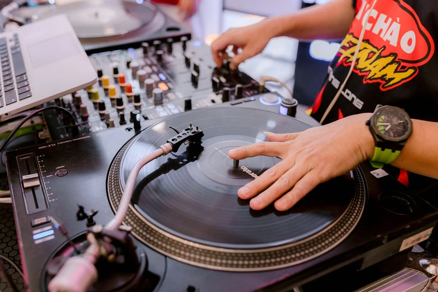 A pair of hands playing vinyl on turntables