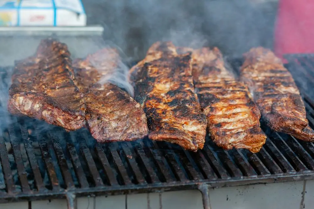 Ribs cooking slowly on a smoking barbecue